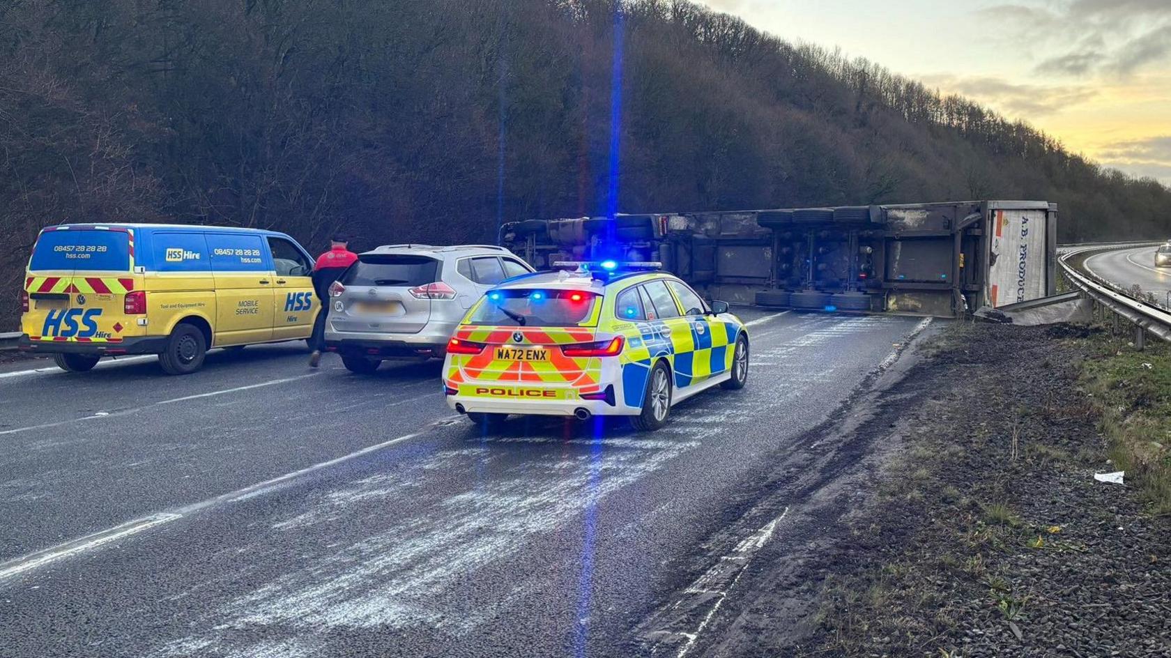 Overturned lorry on the M5 with police cars at the scene