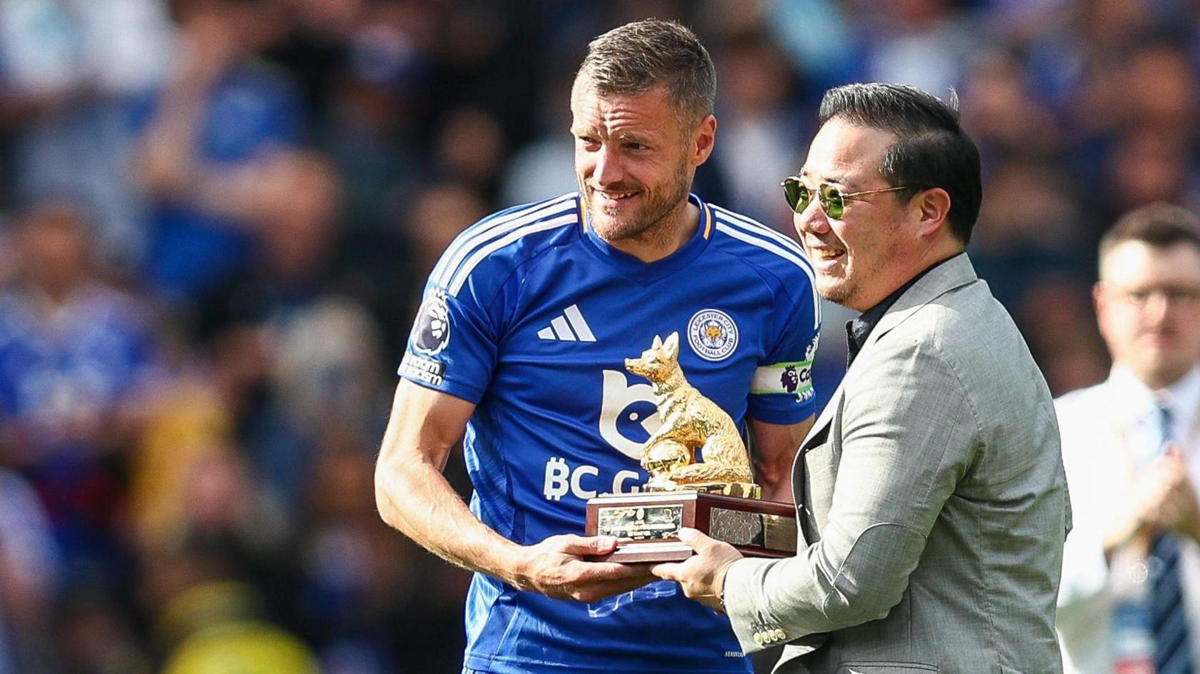 Jamie Vardy of Leicester City receives a commemorative piece from the Leicester City owner