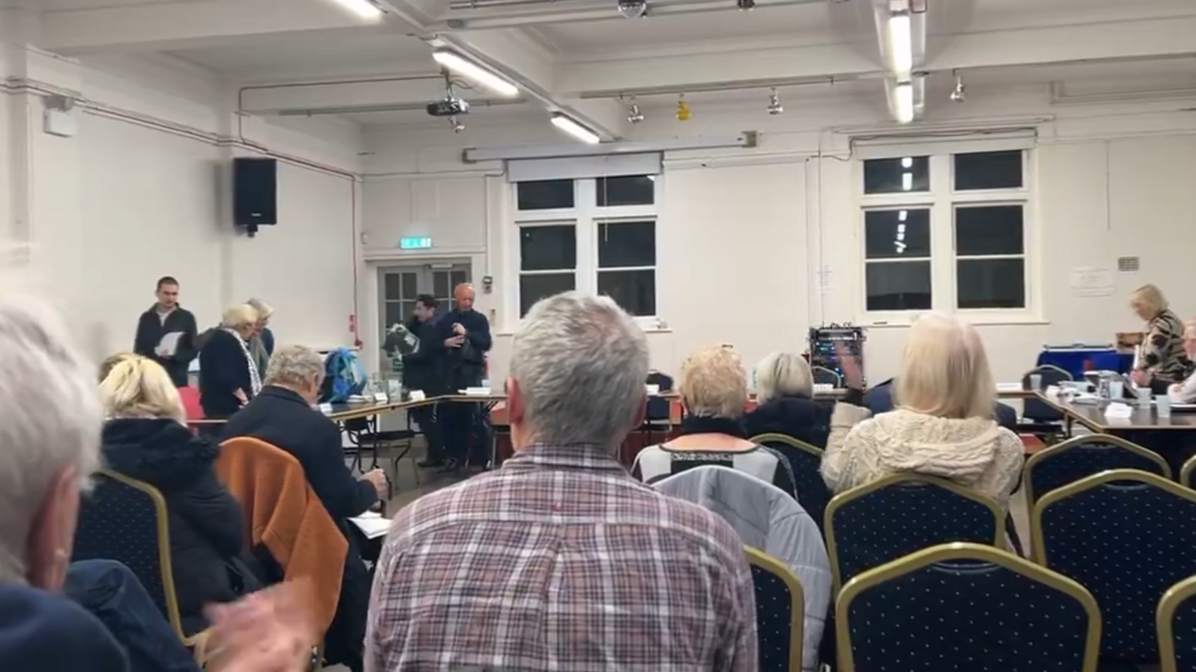 People with their backs turned at a council meeting