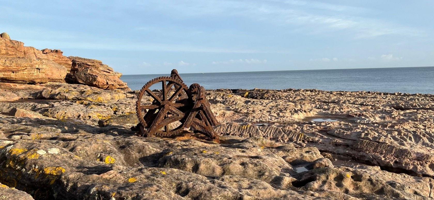 A rusted old winch sits on a rocky outcrop on the east coast of Scotland