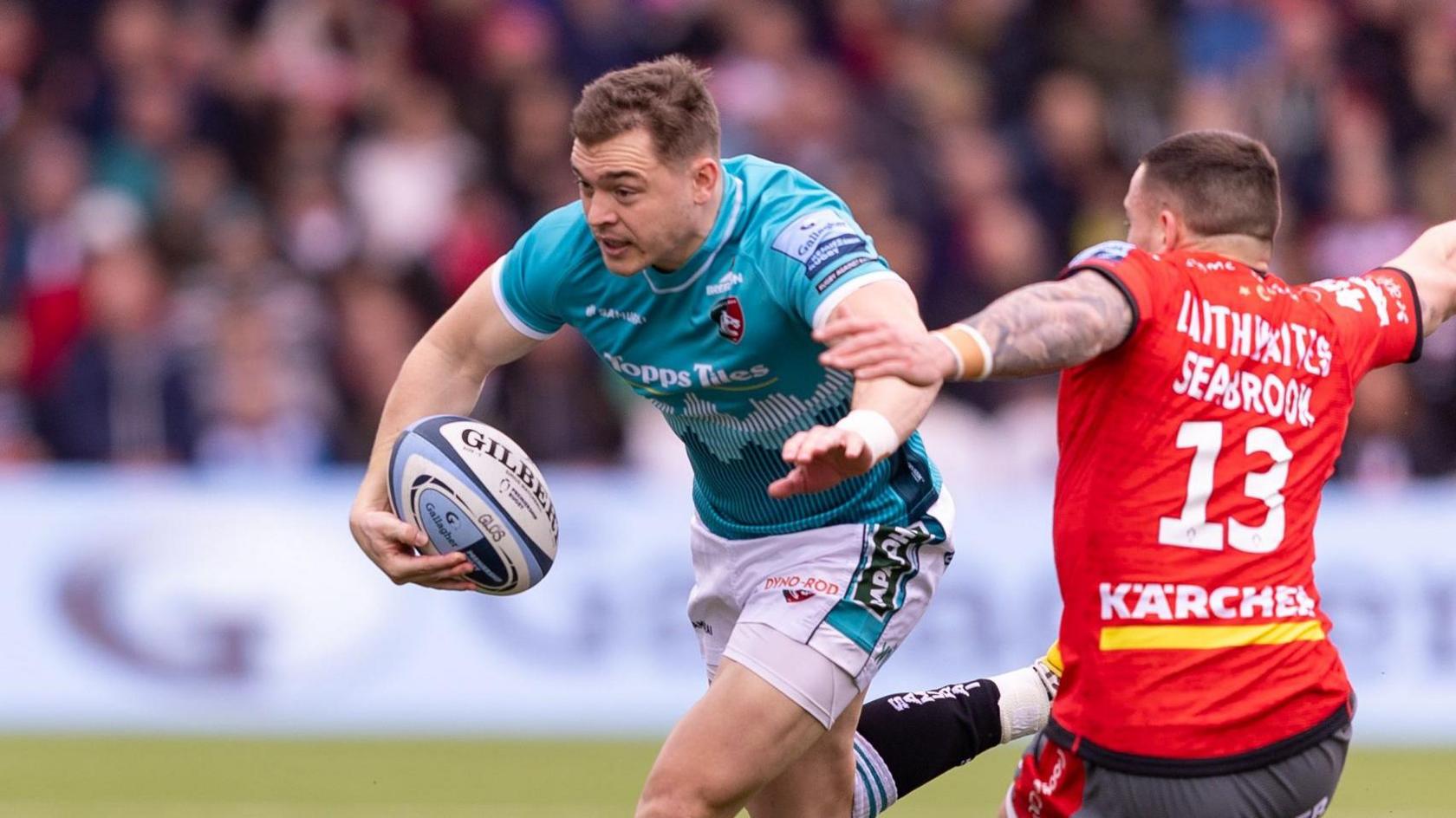 Harry Simmons runs with the ball while in action for Leicester Tigers