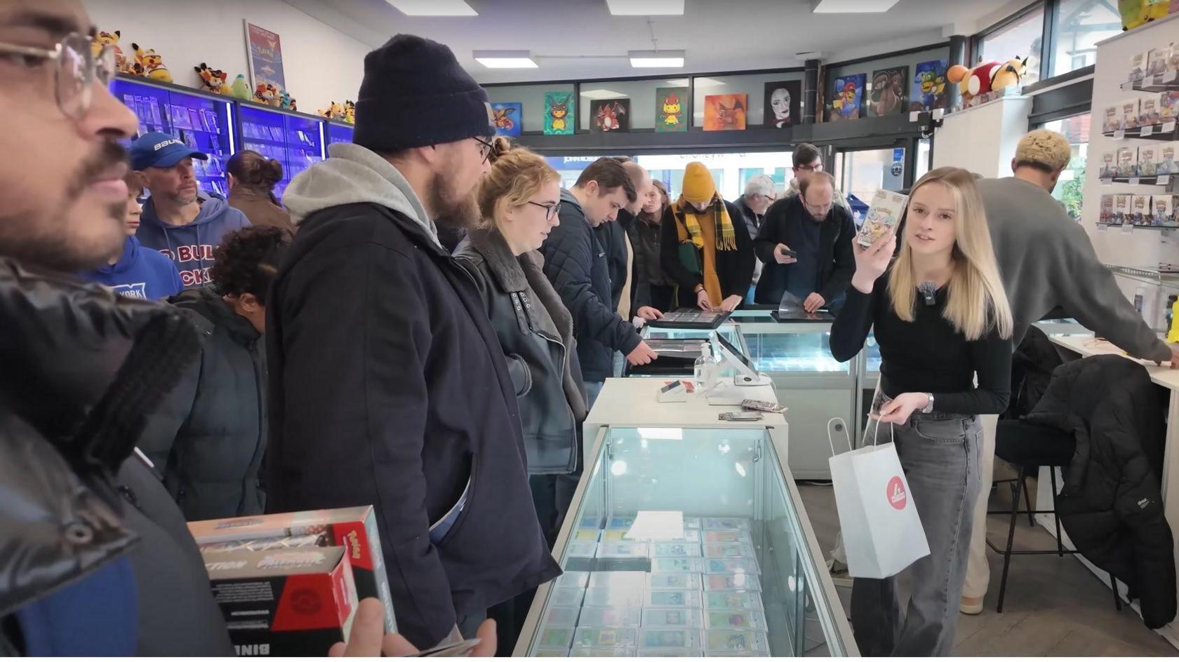 A still from one of PokiChloe's video shows a busy shop packed with people as Chloe and Dean try to serve customers