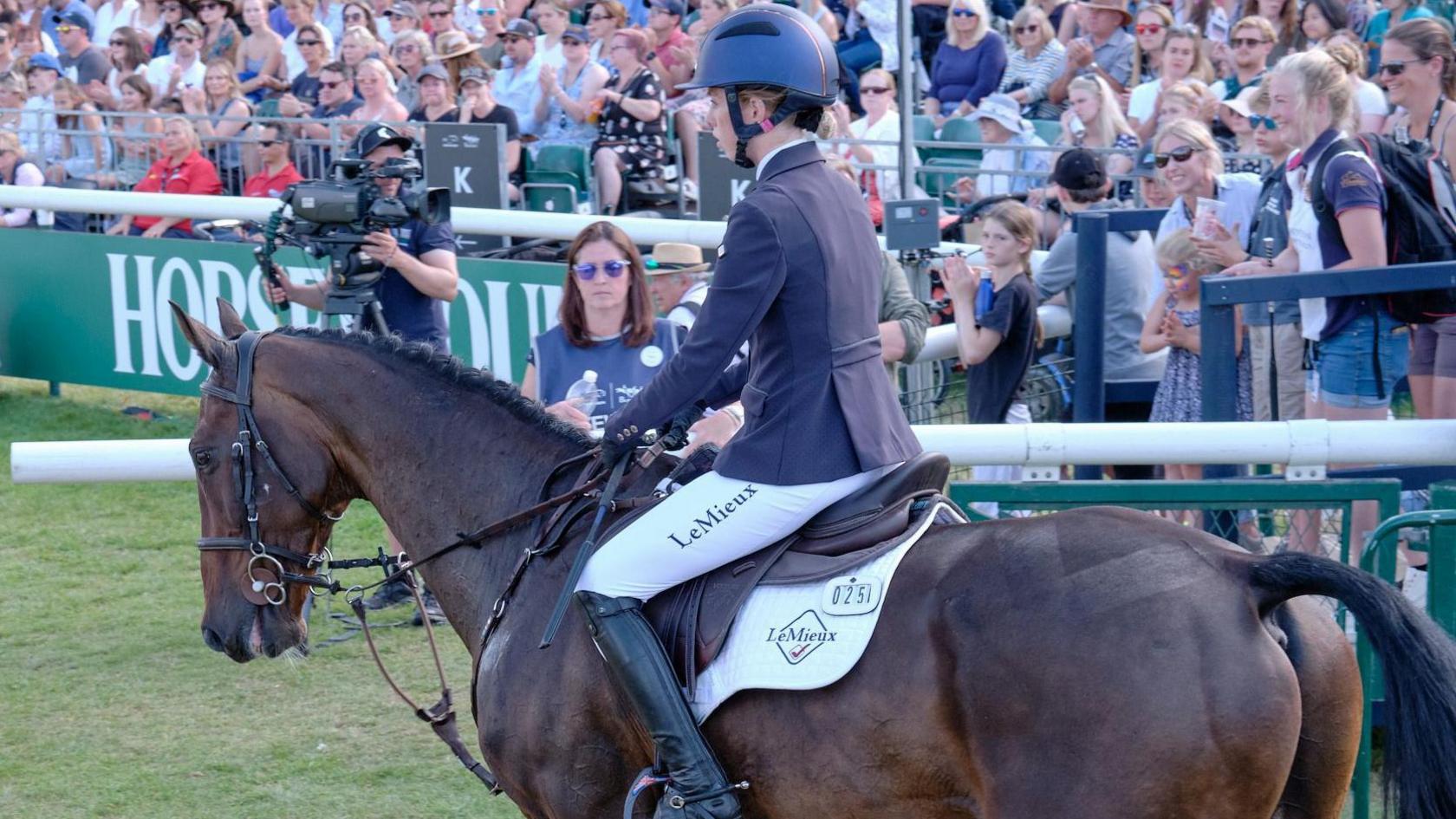 Casburn waiting on a horse before an event takes place, as the crowd watches on 