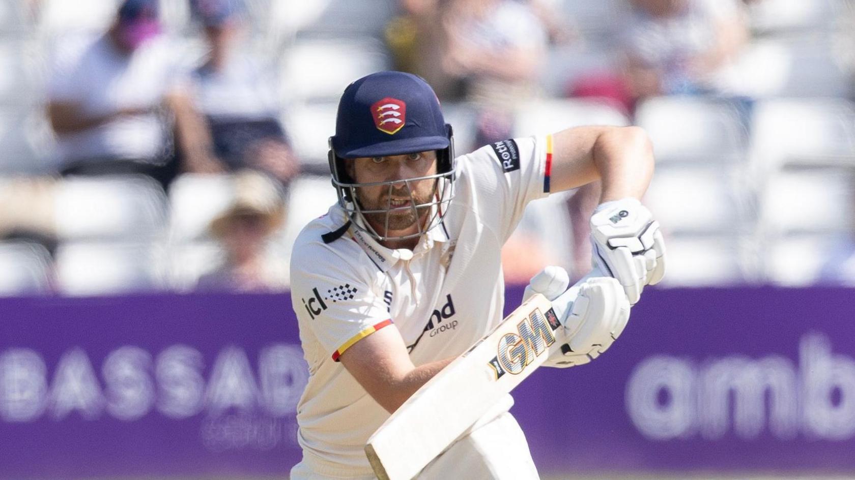 Essex batter Matt Critchley intently watching the ball as he knocks it into the offside