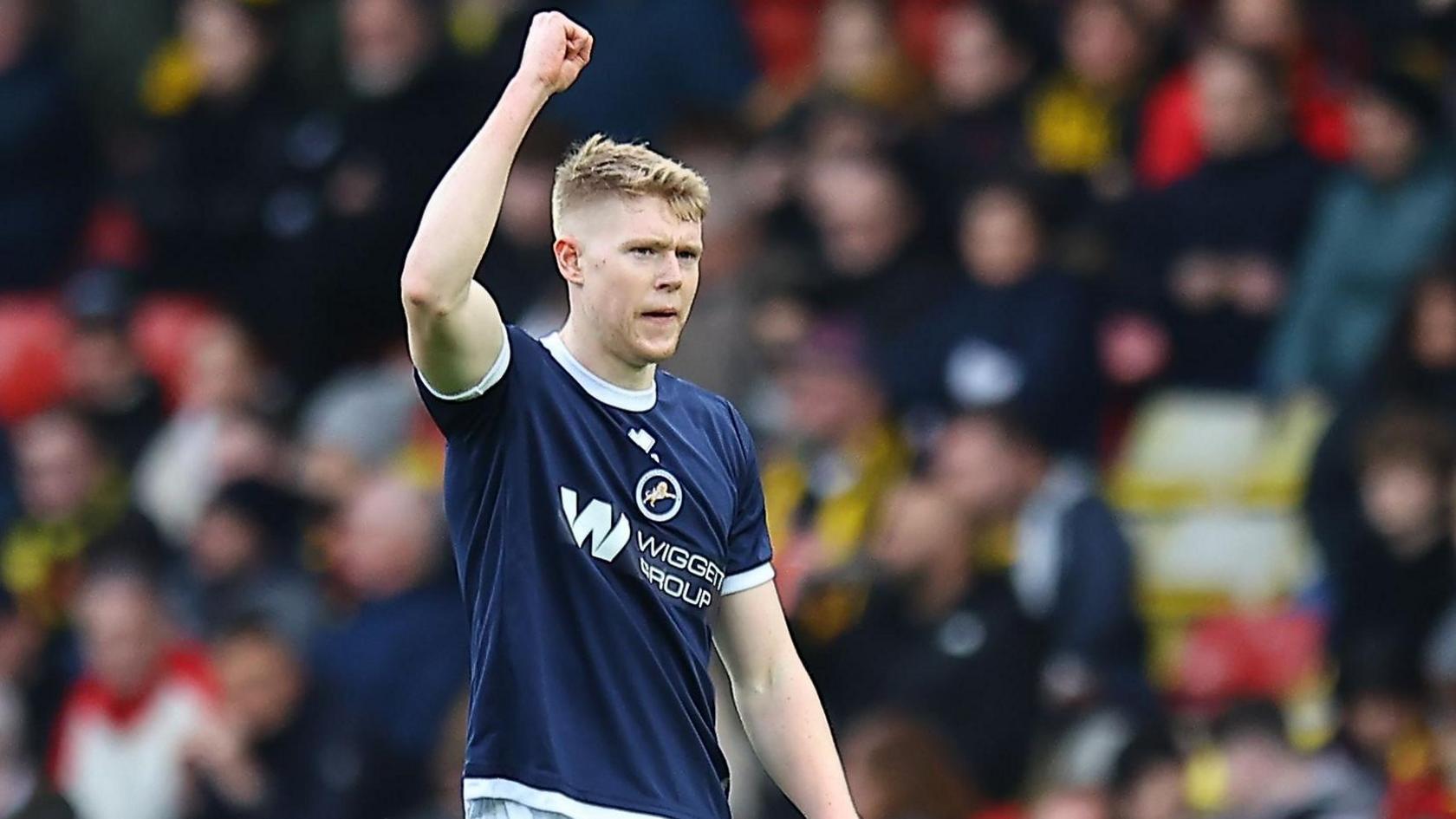 Josh Coburn celebrates with his arm raised