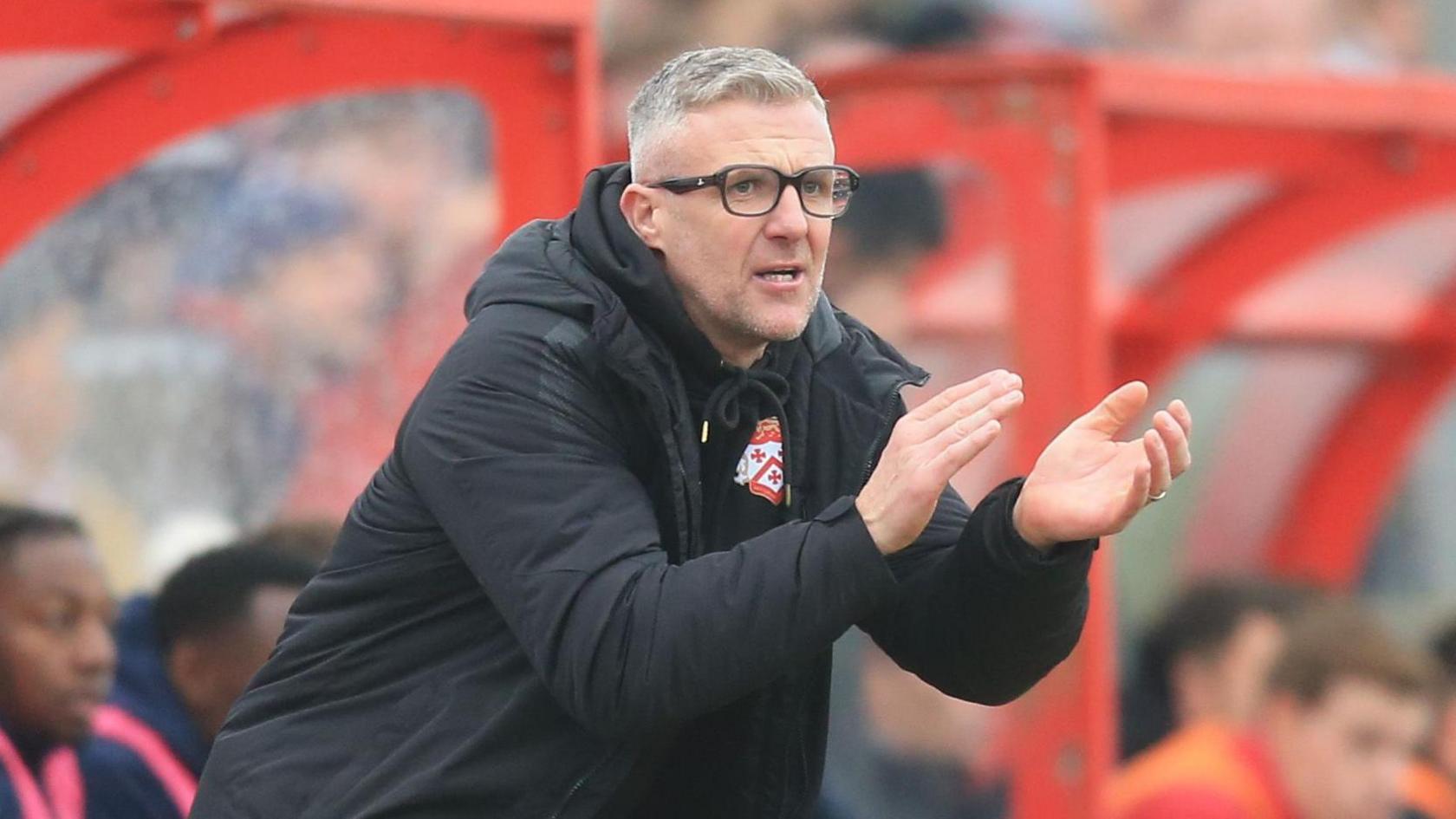 Richard Lavery claps his hands in the dugout