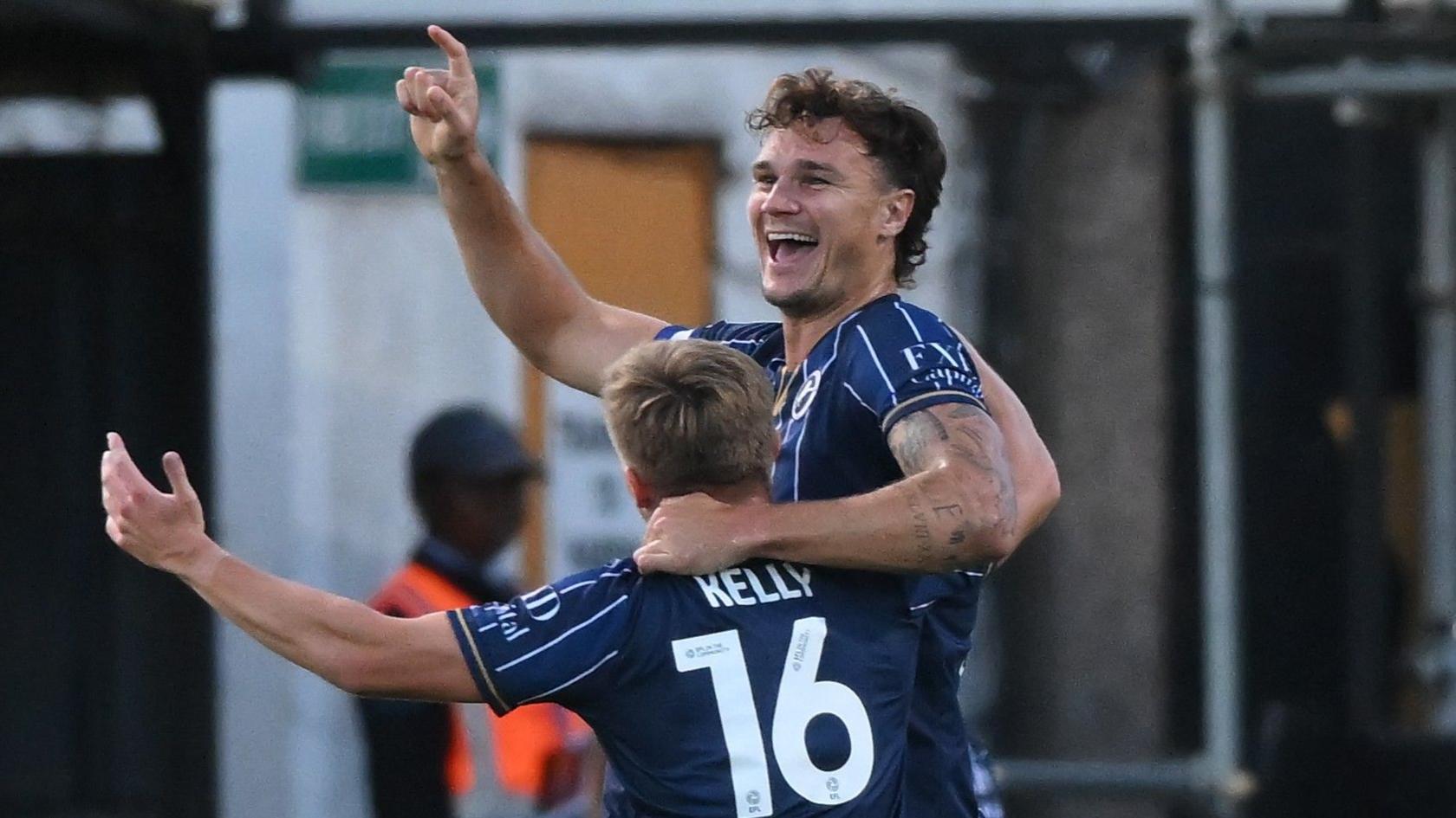 Millwall's Jake Cooper celebrates his goal at Cambridge with team-mate Dan Kelly
