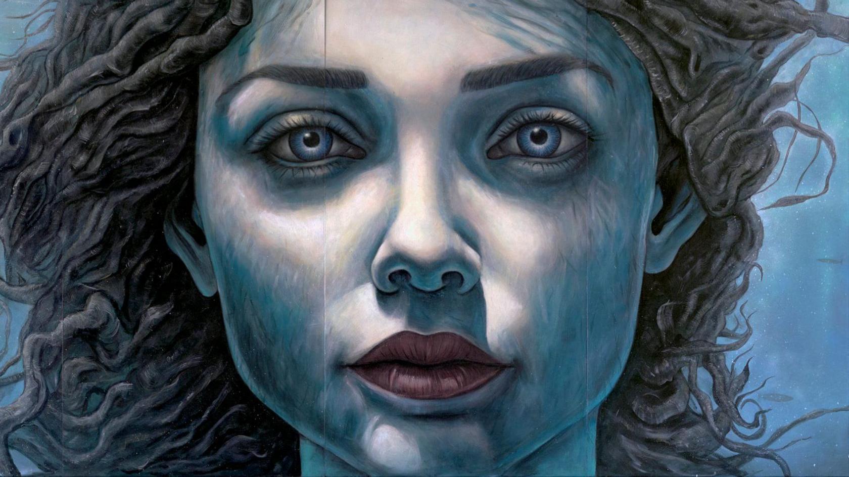 The mural is a close up of a young woman's face painted in shades of blue, giving the impression she is under water. She has long dark hair that appears to be floating in the water behind her.