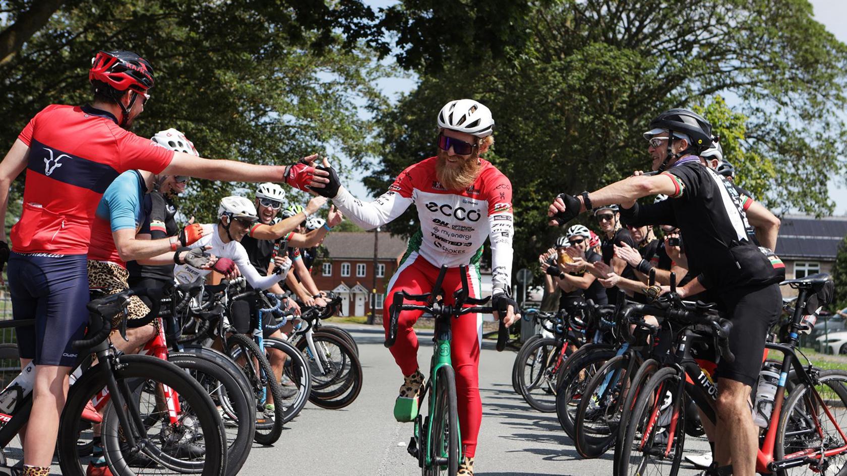 Sean Conway on bike with other cyclists around him