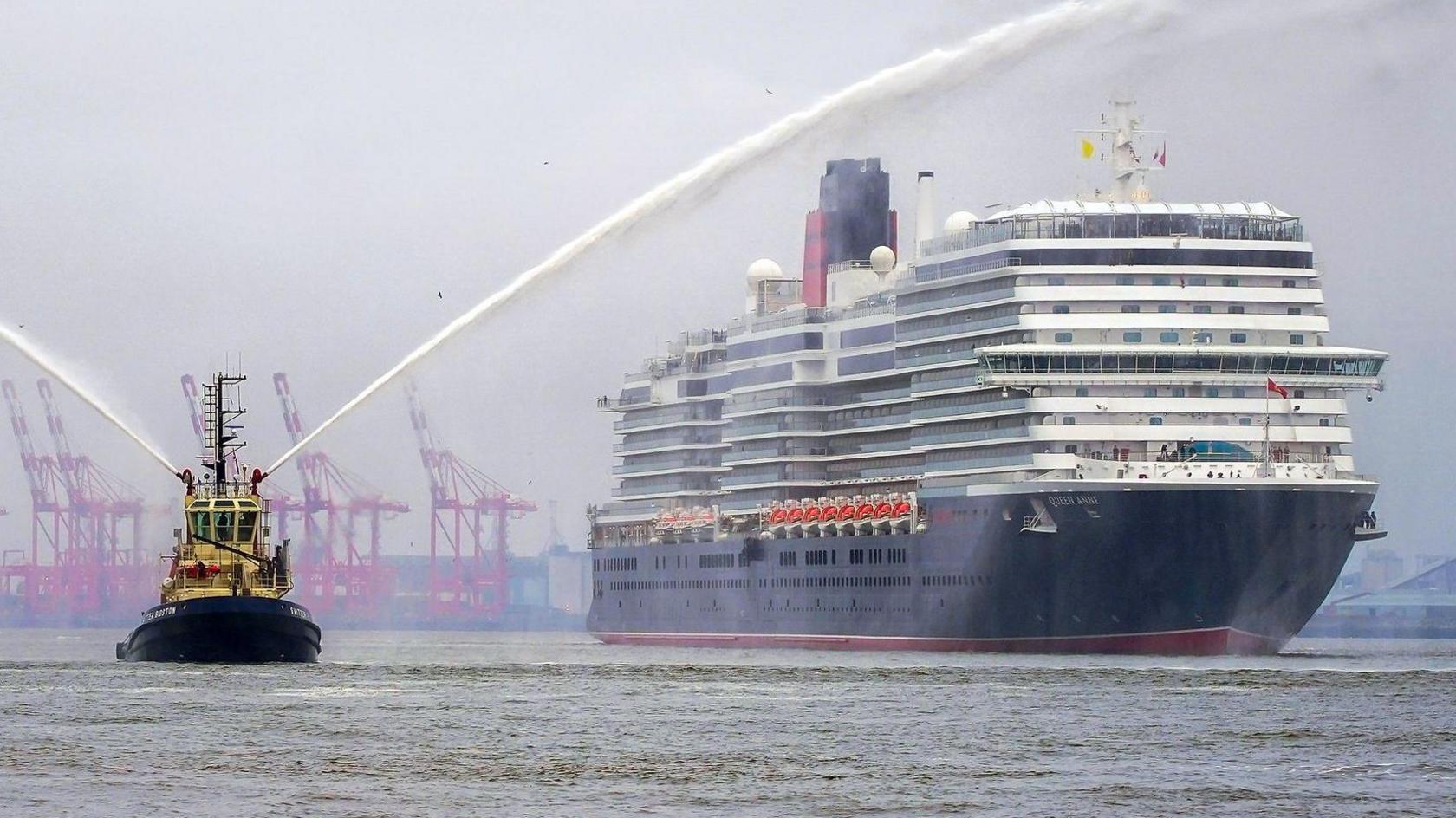 Cunard cruise ship the Queen Anne is escorted by a tug boat on the River Mersey