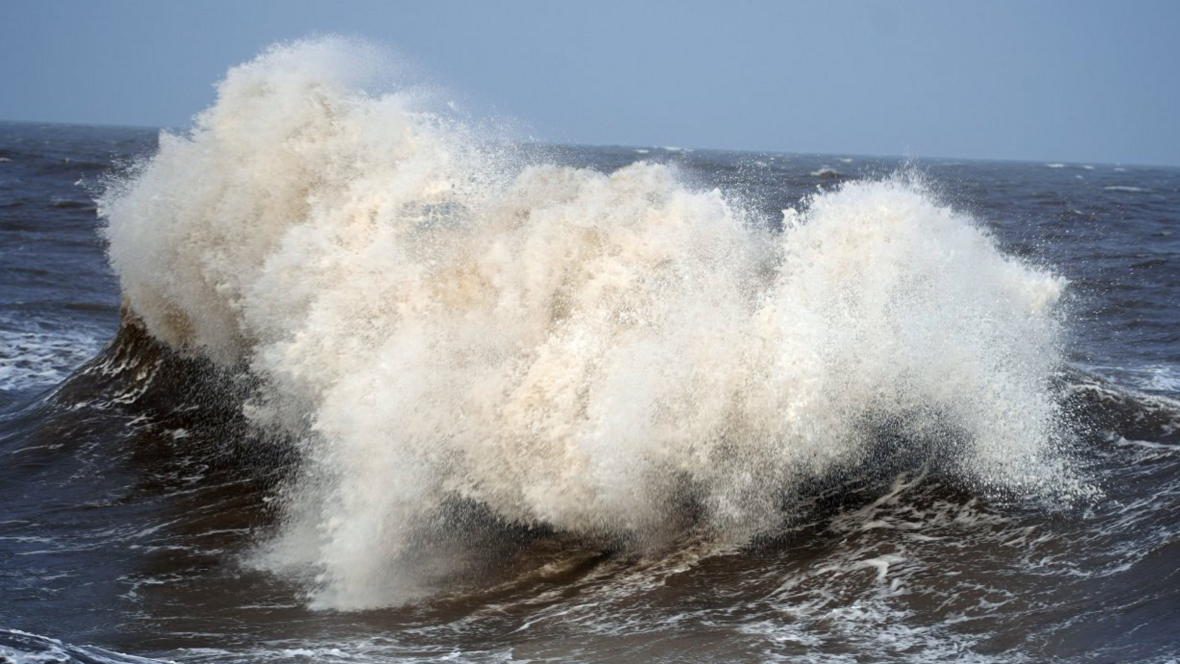 A large breaking wave formed at sea.