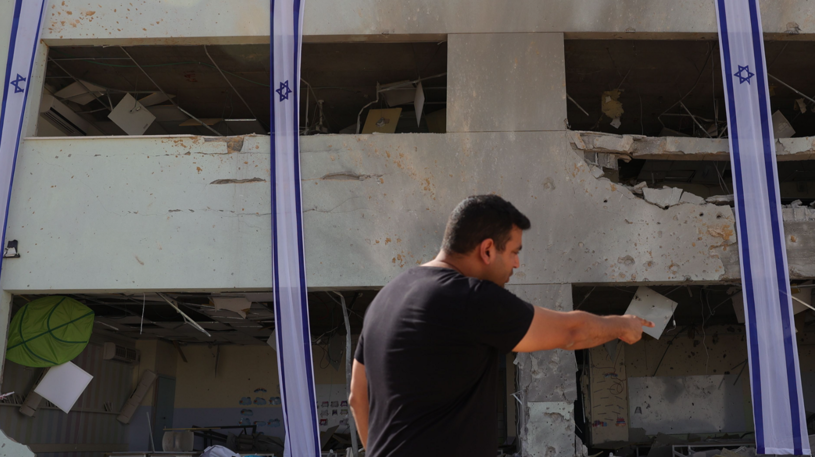 A municipality worker inspects a school damaged by ballistic missiles fired from Iran, in Gedera, Israel, 02 October 2024