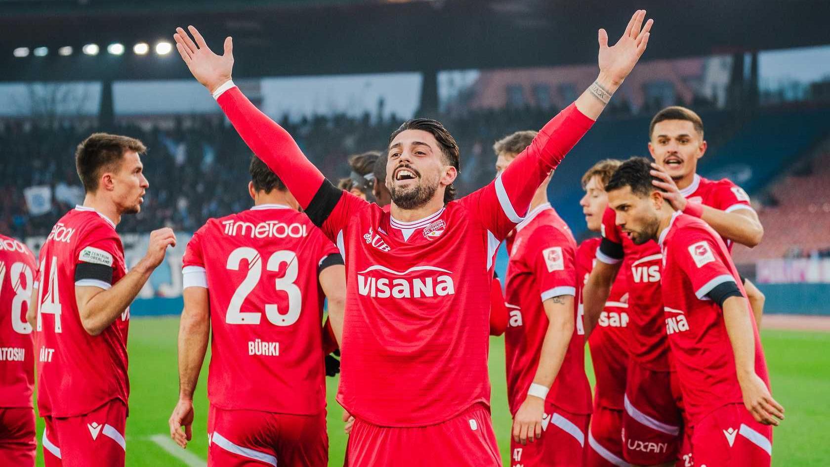 Kastriot Imeri raises his arms in celebration