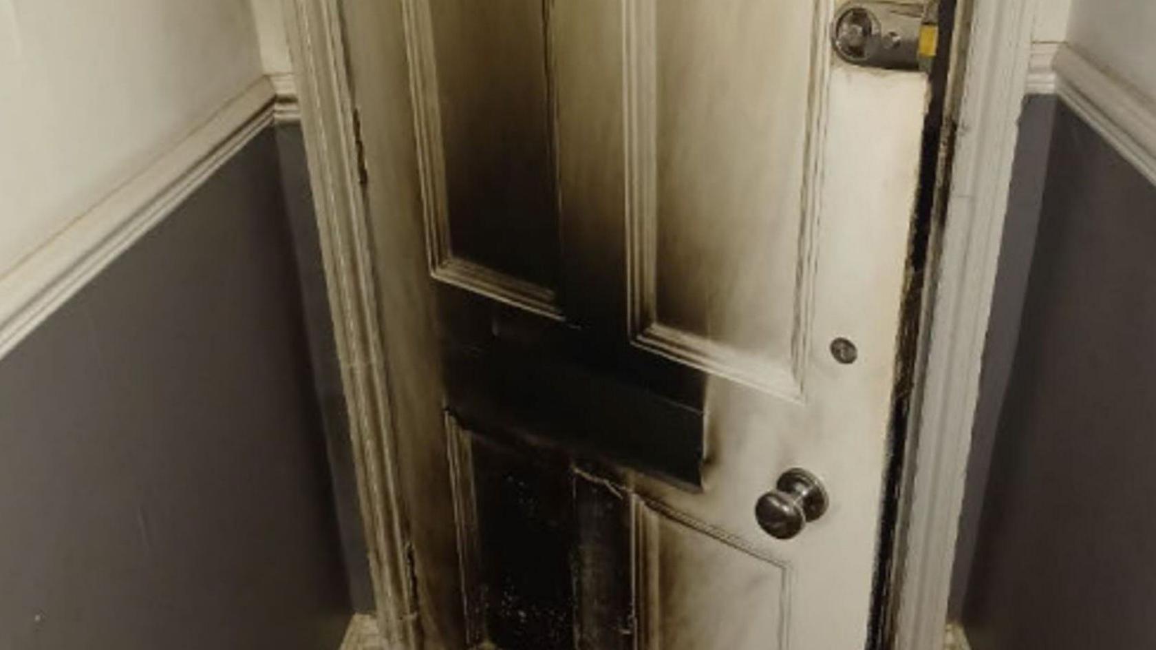 A fire-damaged front door