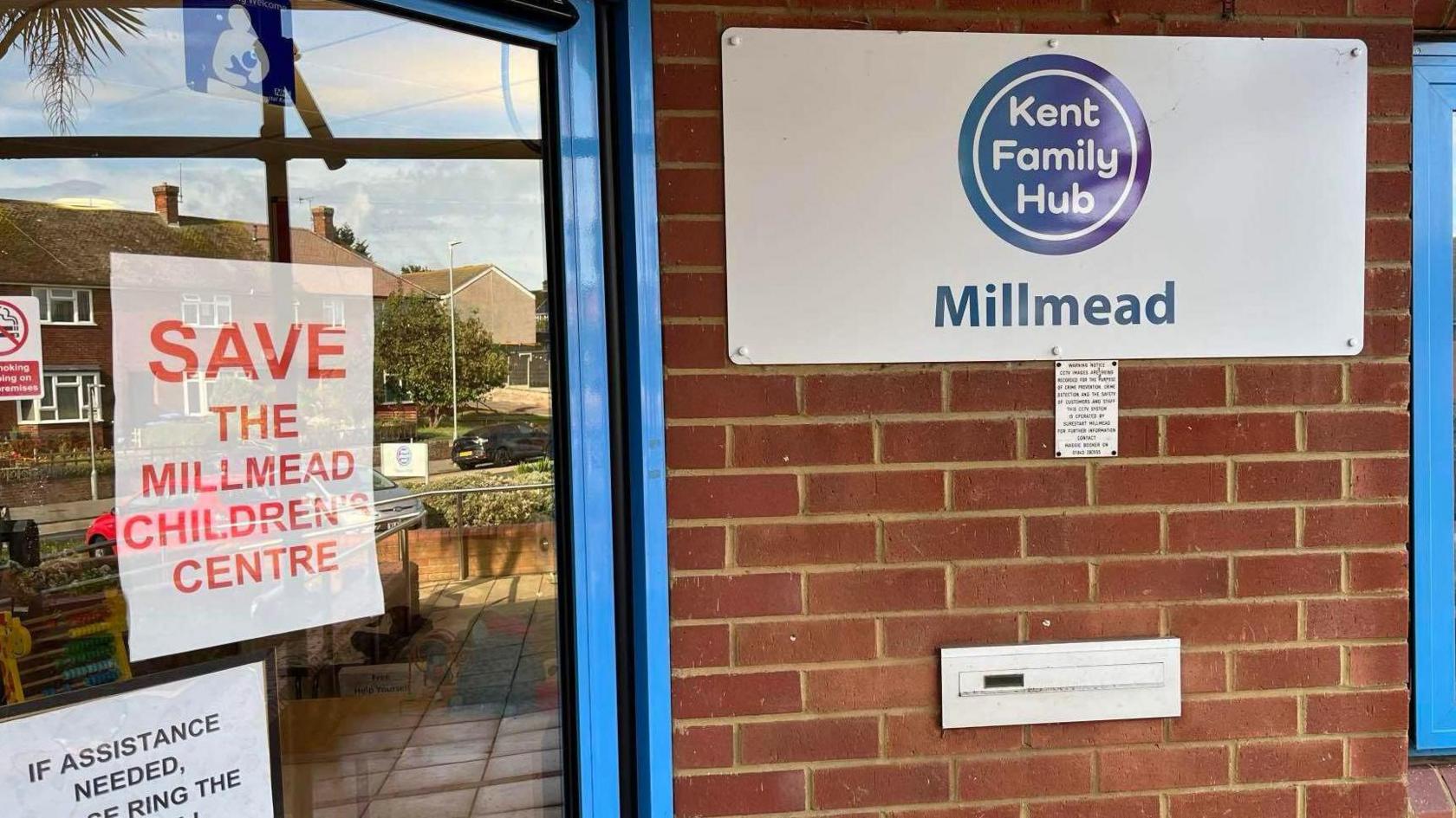 The Millmead Centre entrance, with a sign in the window saying Save the Millmead Children's Centre.