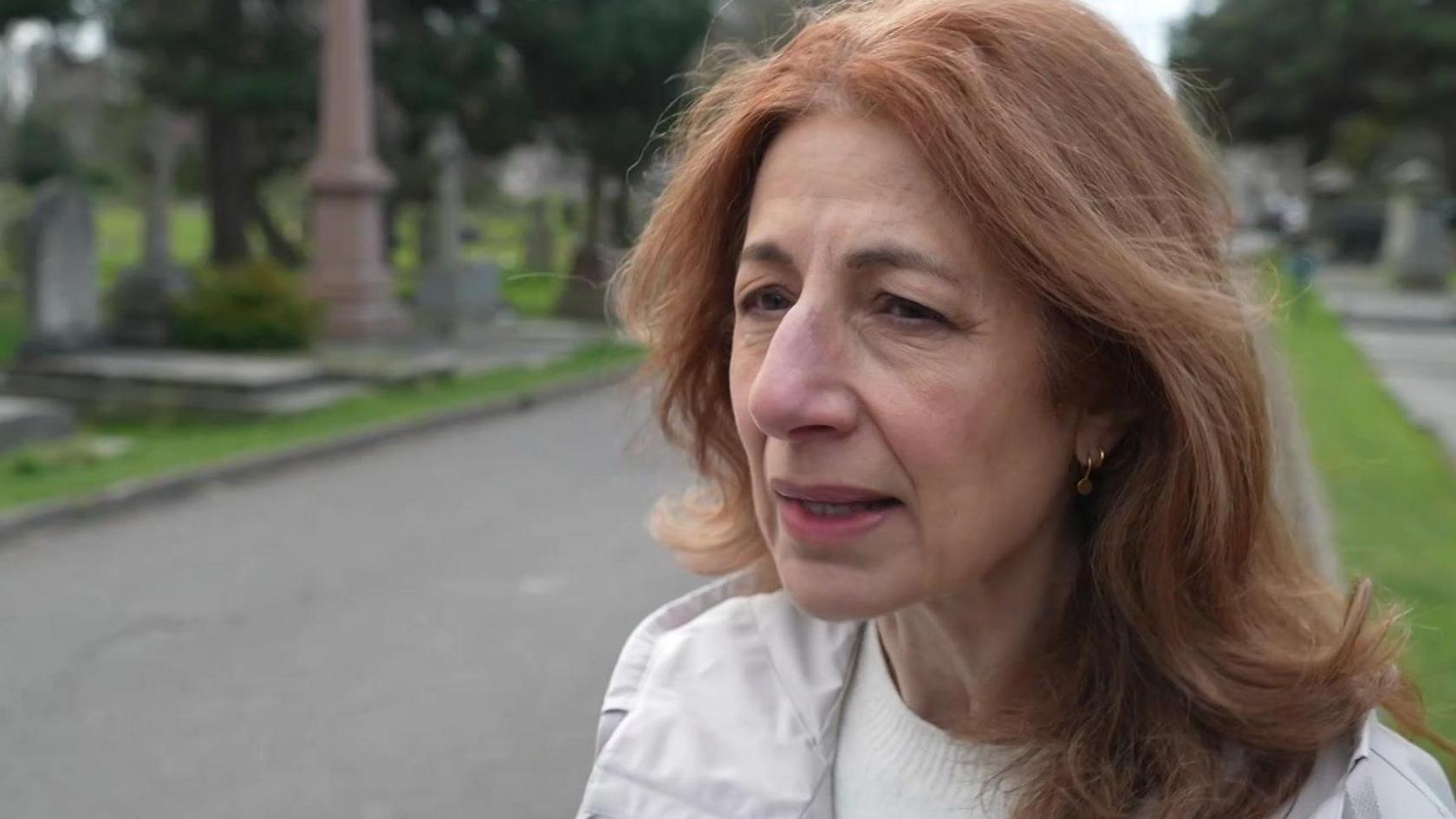 Eleni Chalmers standing in the cemetery 