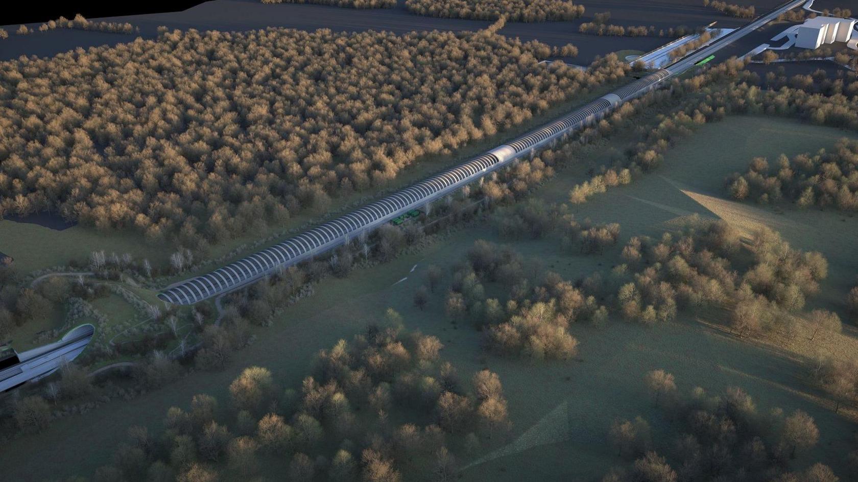 Ariel view of an artist's impression of Sheephouse Woods with the railway running alongside it, covered by the curved barrier to protect bats - which looks like a tunnel that is above ground.