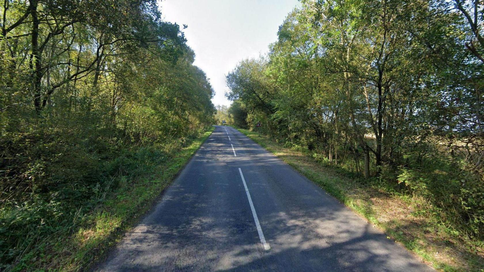 The B6260 is a rural road bordered by tall trees.