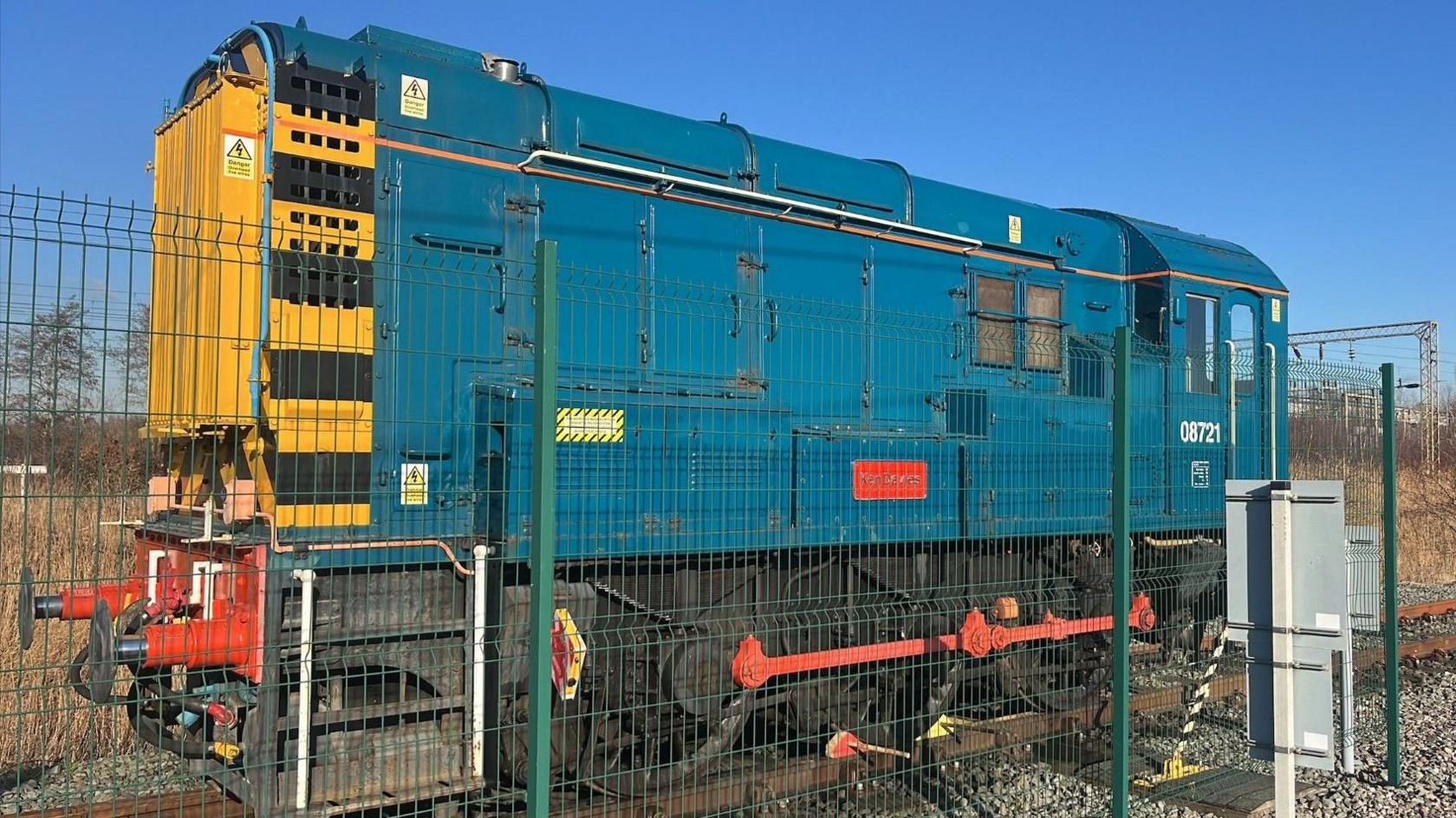 The Class 08 locomotive train. It is teal colour with a yellow front.