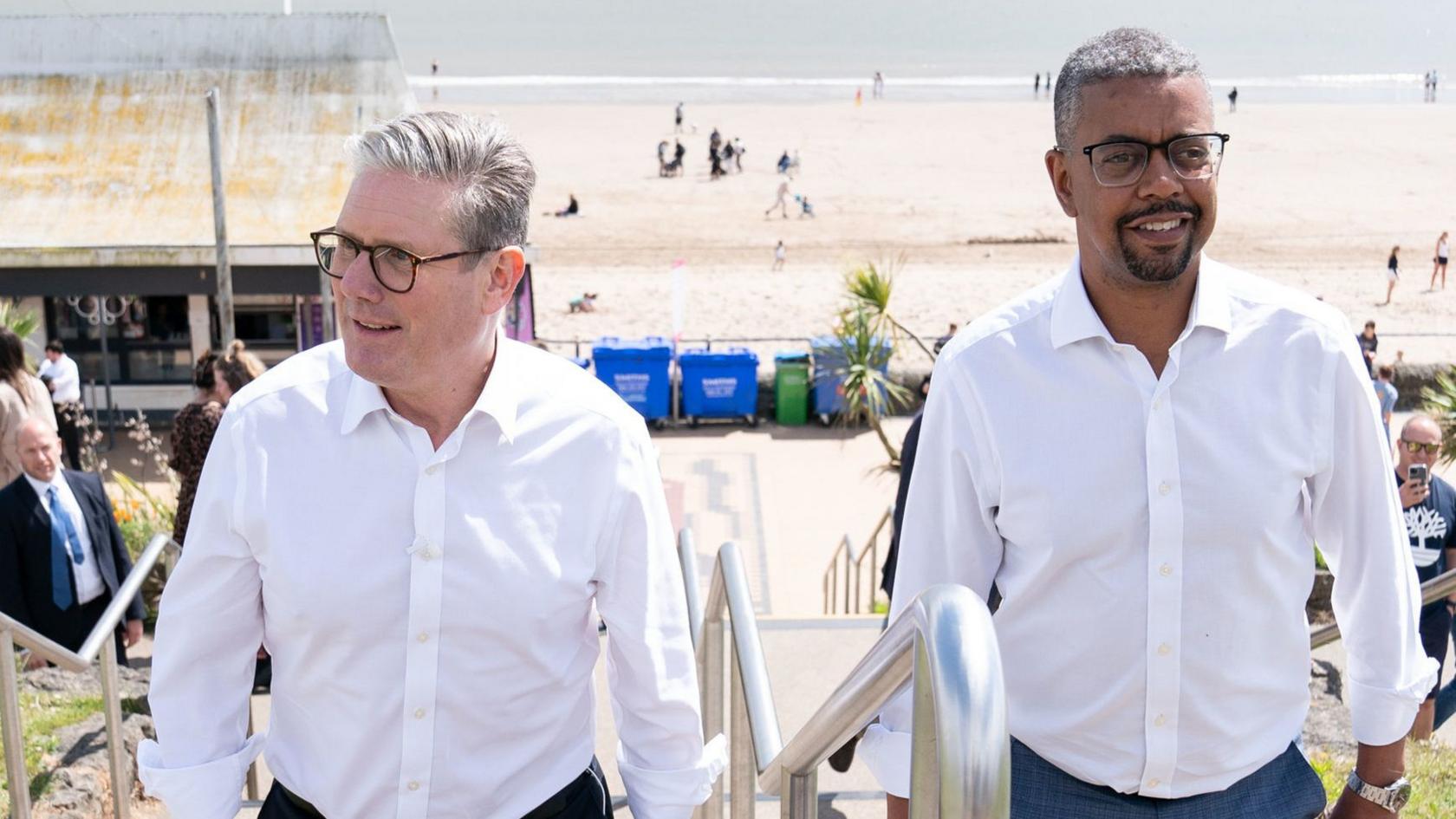 Sir Keir Starmer and Vaughan Gething walking steps at Barry Island