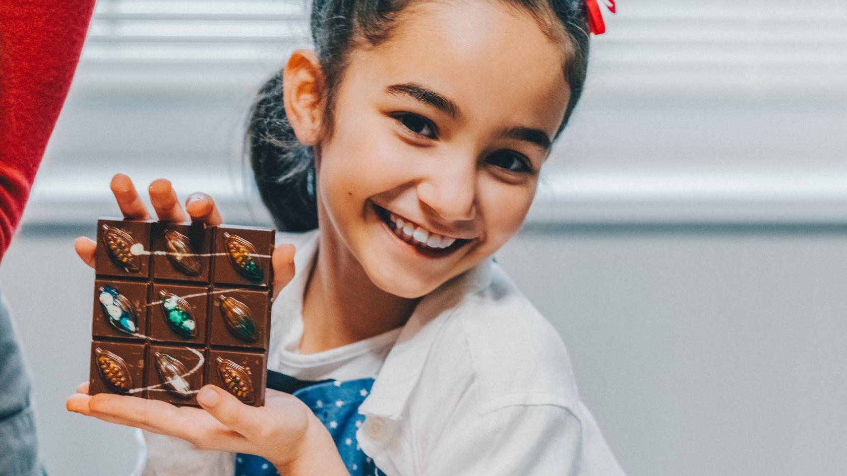 girl-holding-chocolate-bar. 