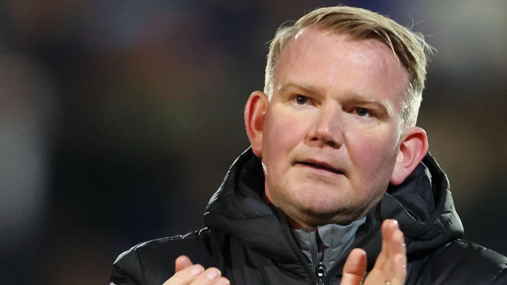 Pete Wild applauds during Tranmere Rovers' fixture against Fleetwood Town earlier this season