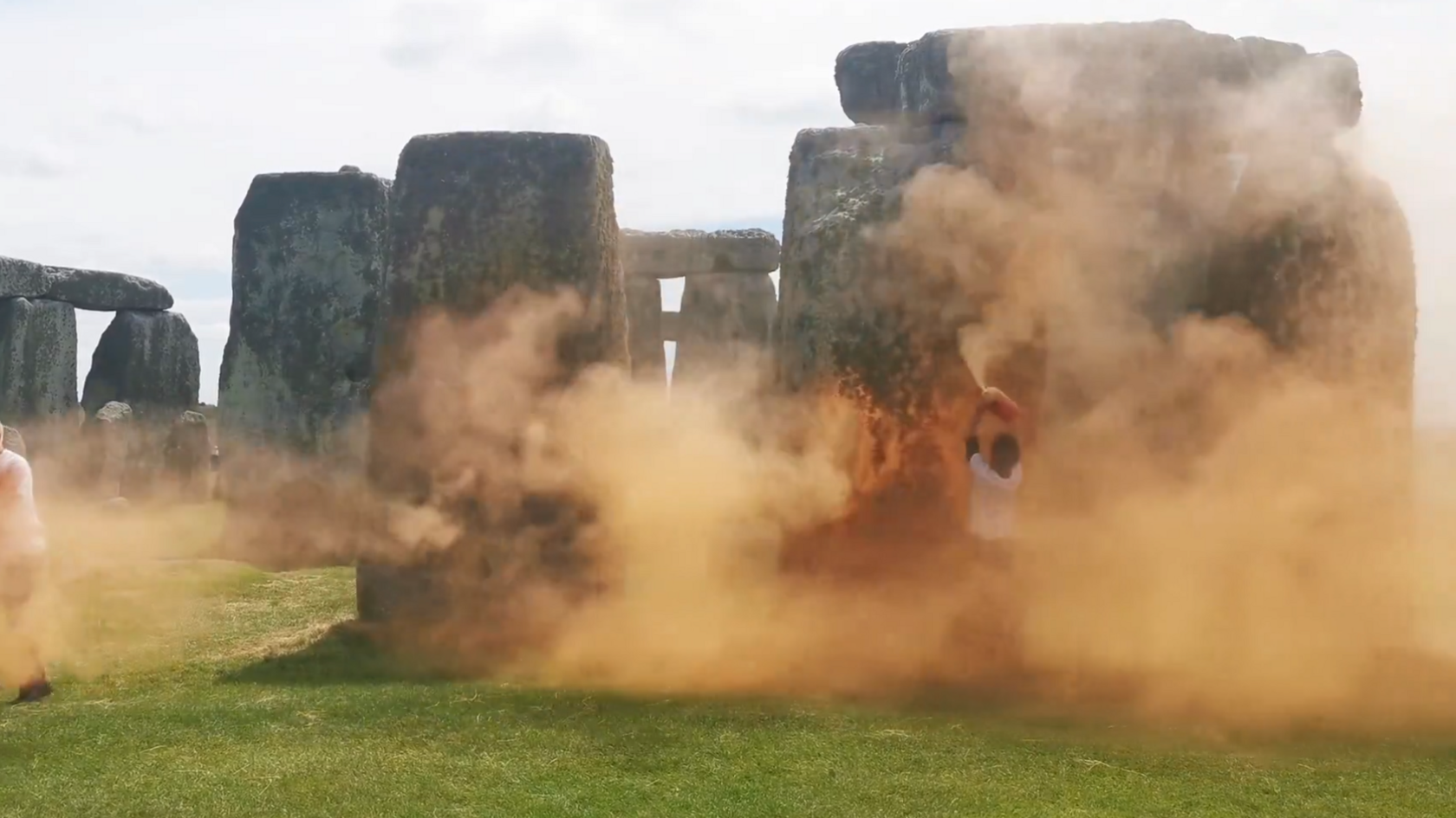 Stonehenge with a cloud of orange paint obscuring it