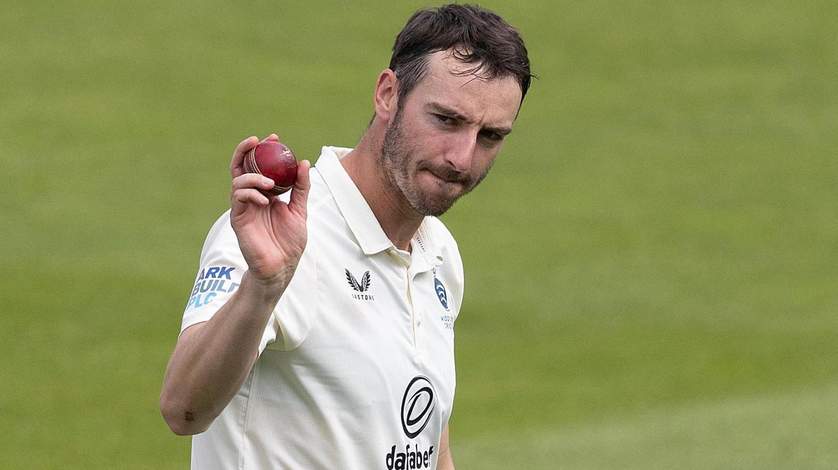 Toby Roland-Jones holds up thee ball after taking five Kent wickets at Lord's