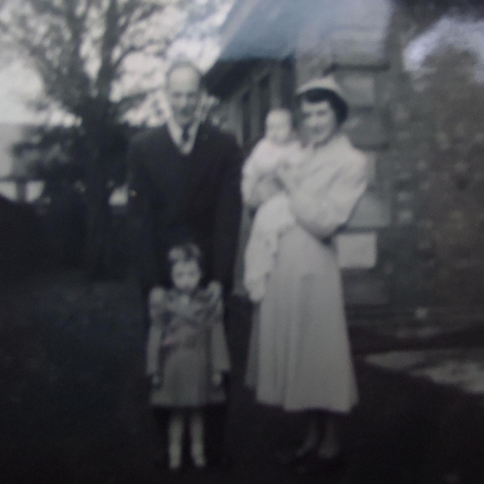 A black and white blurry photo of Ms Hart and her family when she was a baby