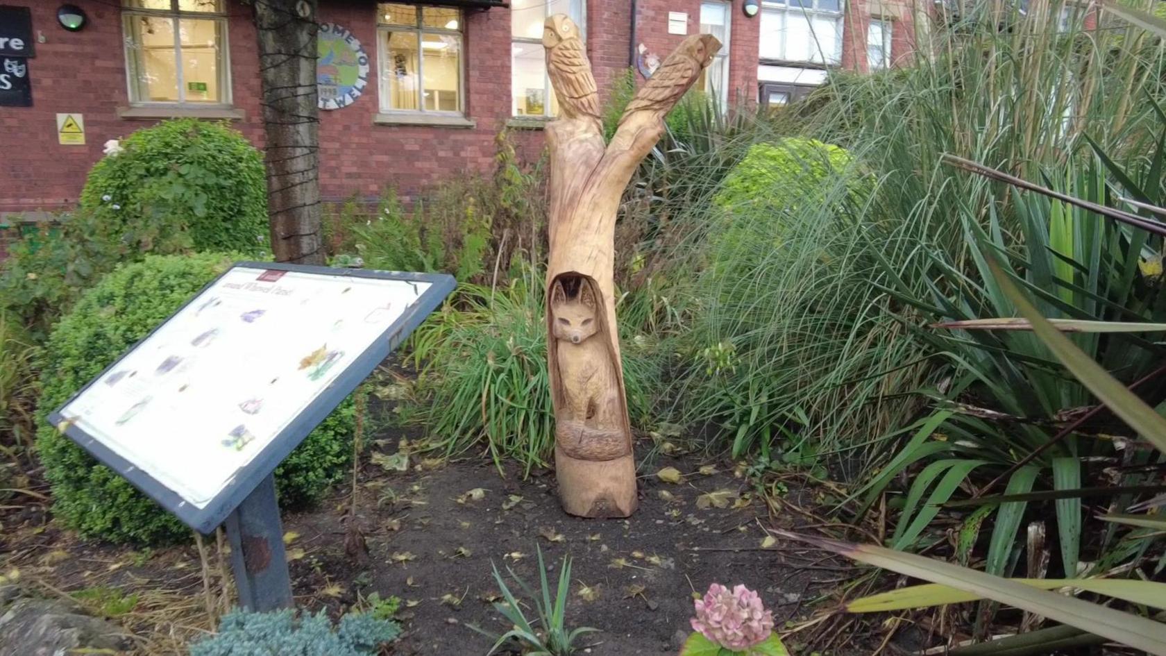 Sculpture of a fox and two owls in Whitwell Community Centre Garden