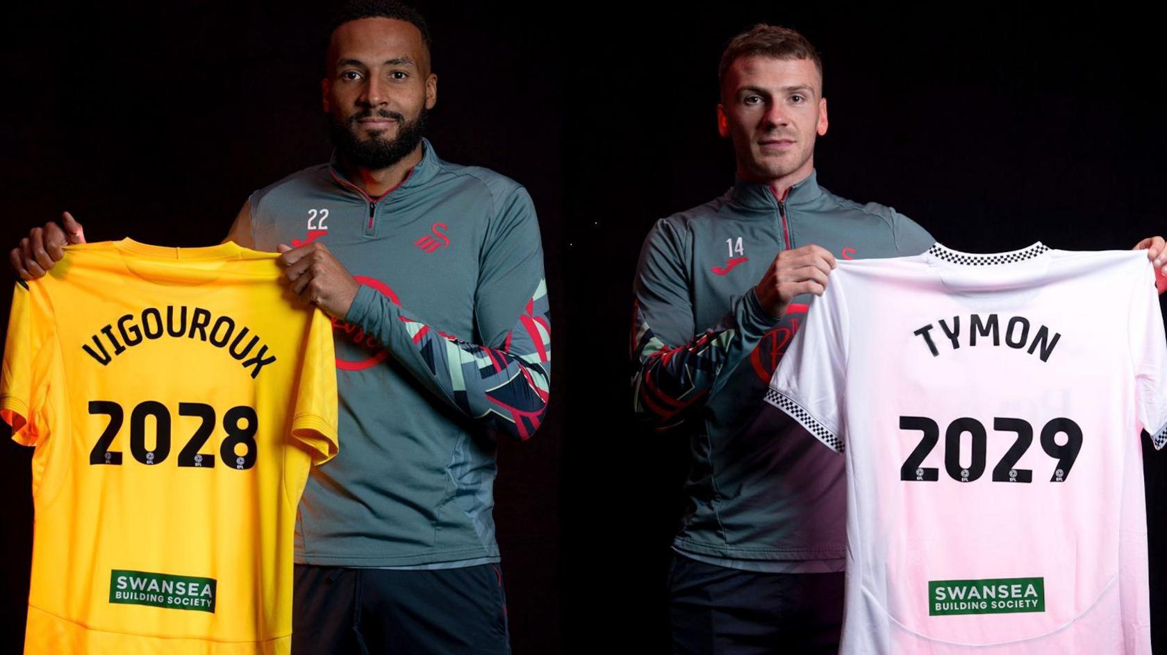Lawrence Vigouroux and Josh Tymon hold up Swansea shirts