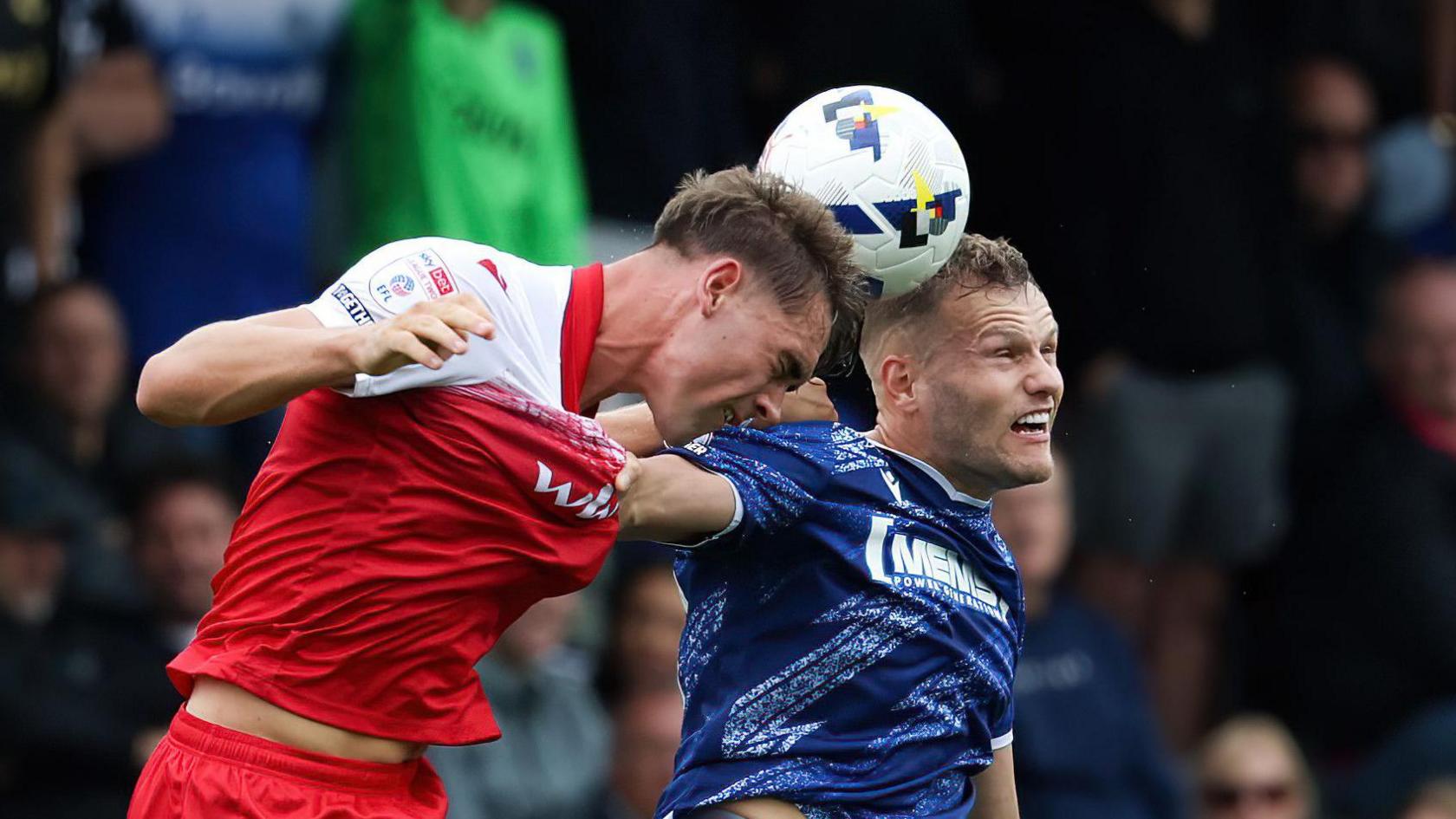 Josh Smith wins a header playing for Accrington against Gillingham