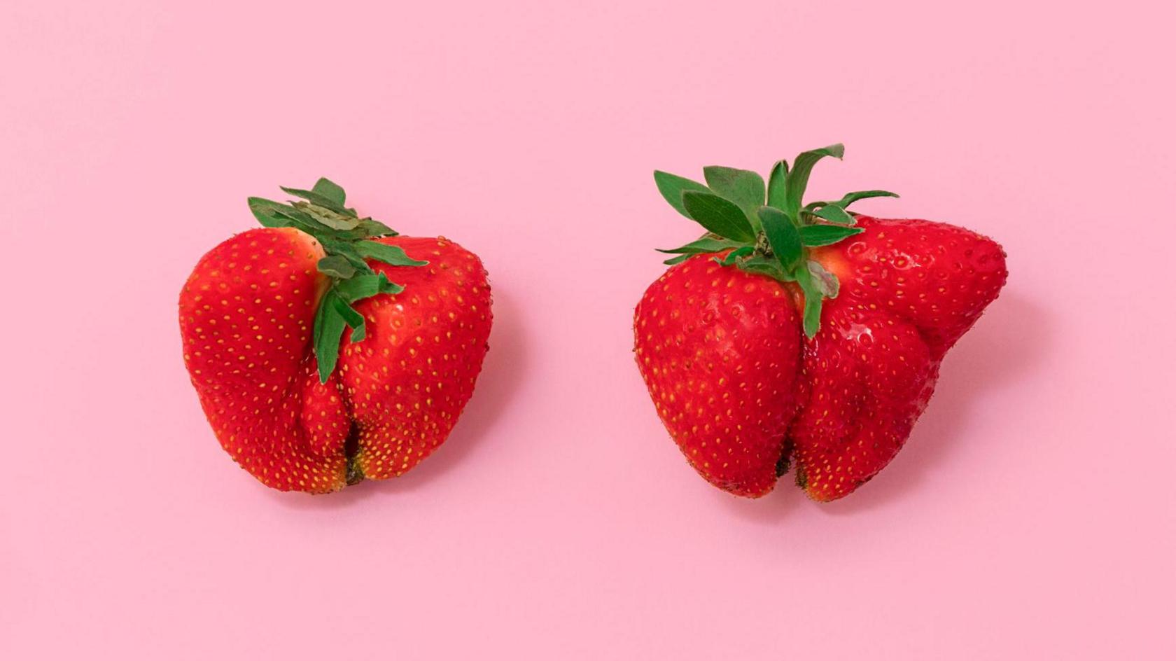 Two unusual shaped strawberries.