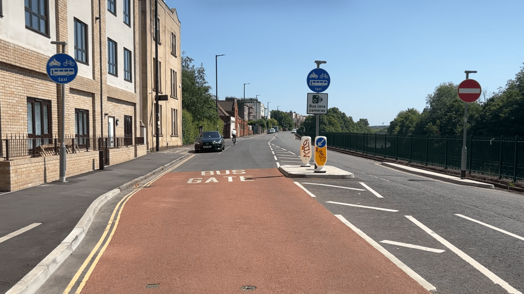 Cumberland Road bus gate seen with signs either side and buildings on one side