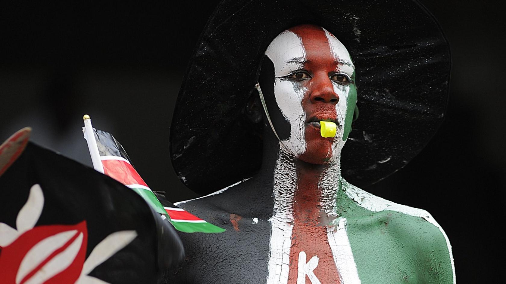 A man painted in the colours of the Kenyan flag at the 50th anniversary celebrations