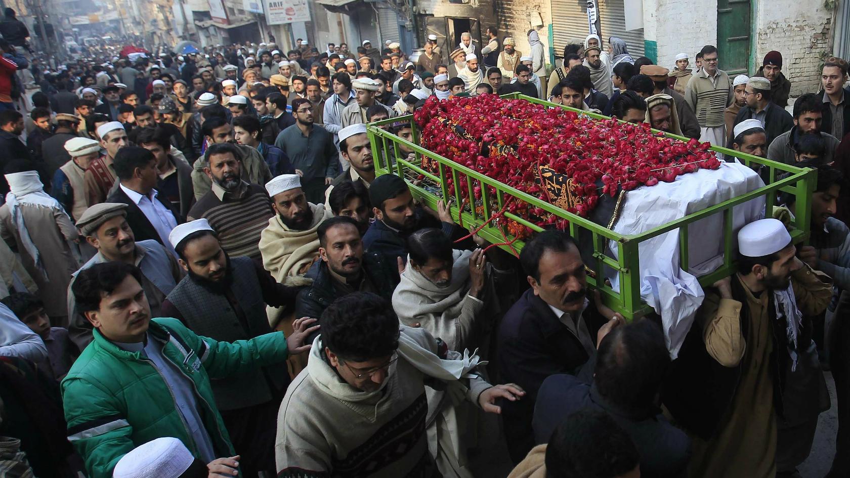 People carry the coffin of a male student who was killed in Tuesday's attack on the Army Public School, during his funeral in Peshawar - 17 December 2014