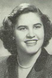 Smiling for the camera, Llewella Humphreys has a pretty round face and dark curly hair. She is wearing a smart suit jacket with a pearl necklace 