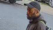 CCTV image of a man police want to speak to, he is wearing a dark baseball cap