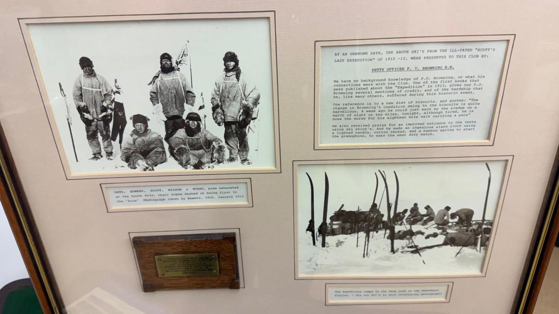 The presentation case has two black and white group photos of the expedition member wearing cold weather gear and hats as they stand in the snow holding ski poles. There is a brass plaque and three boxes of typewritten information which is to small to read in this photo.