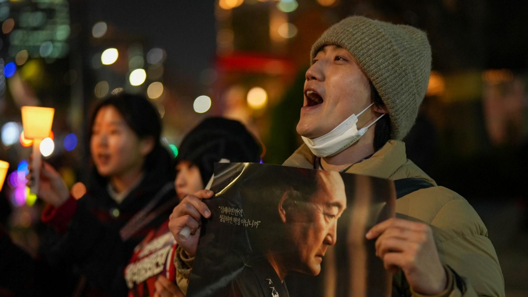 A man  holding a protest sign