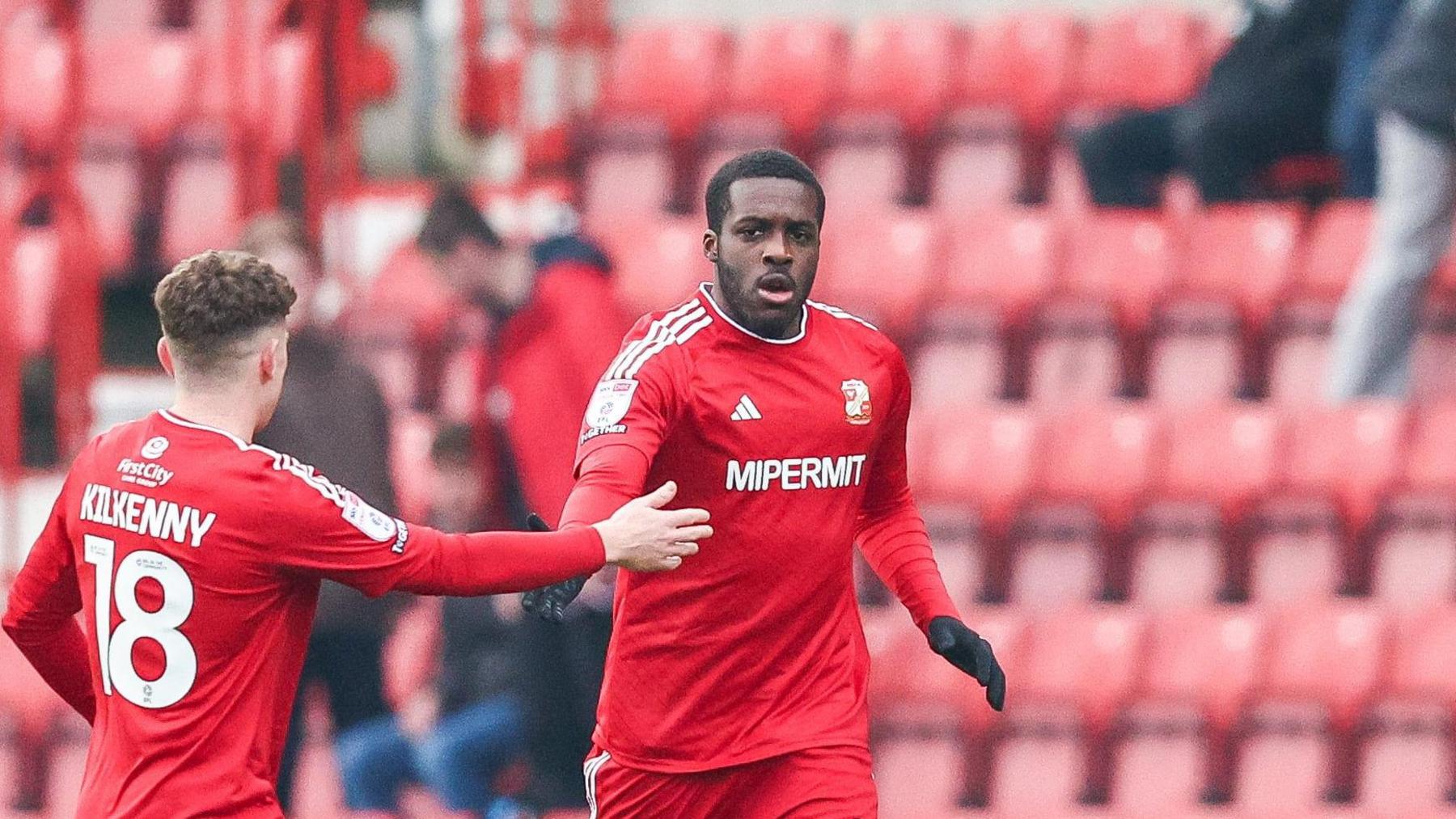 Nnamdi Ofoborh (right) in action for Swindon Town