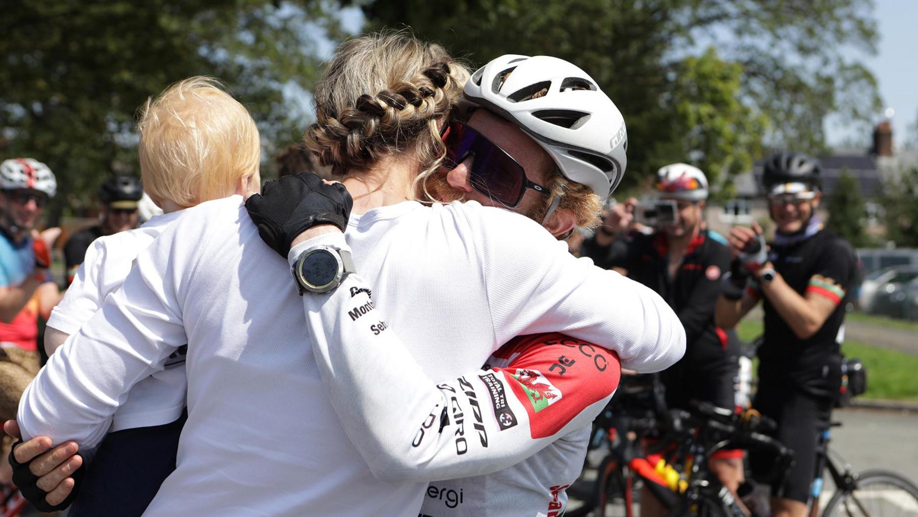 Sean embracing Caroline after cycling