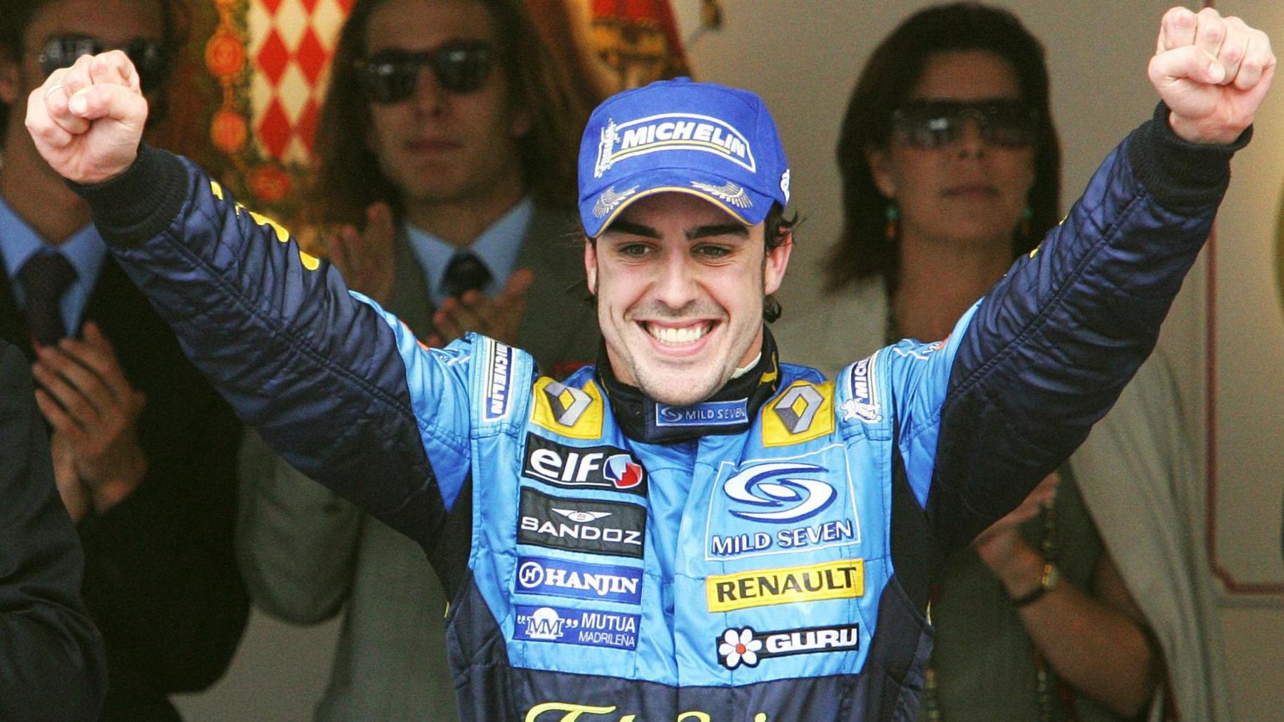 Renault's Fernando Alonso lifts his arms aloft in celebration after his victory in 2006