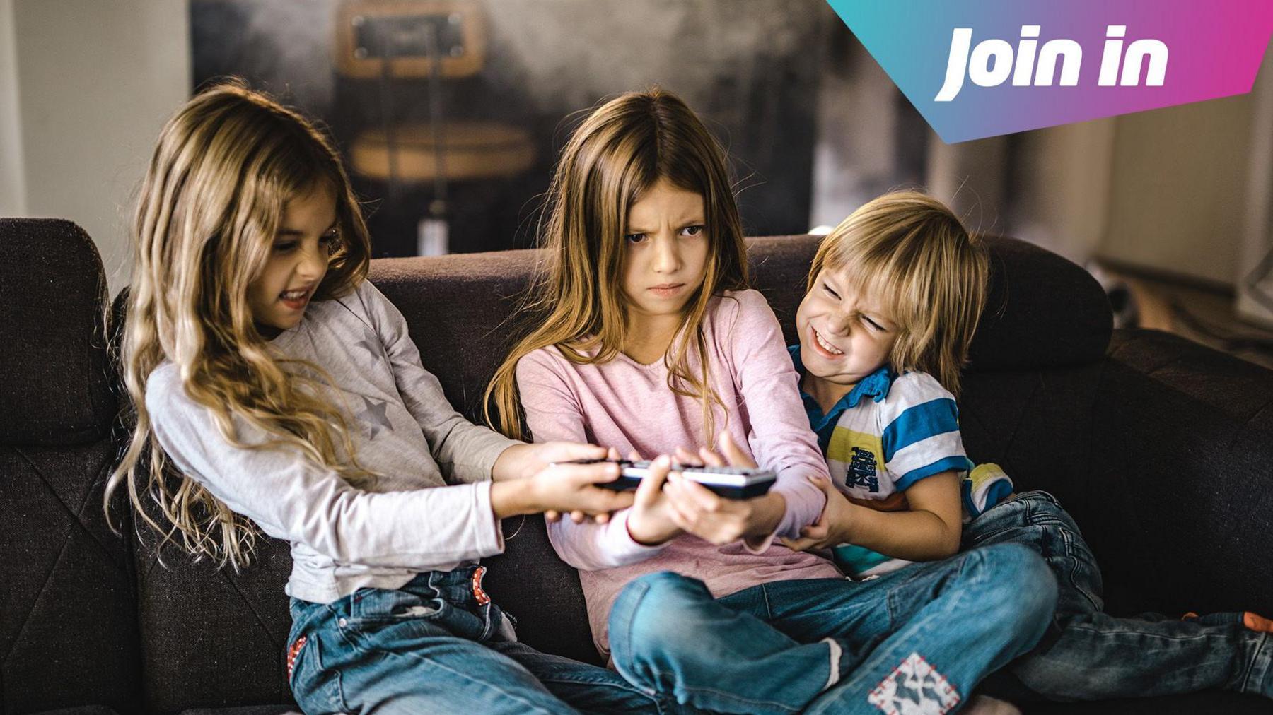 3 siblings fight over a tv remote on the sofa 