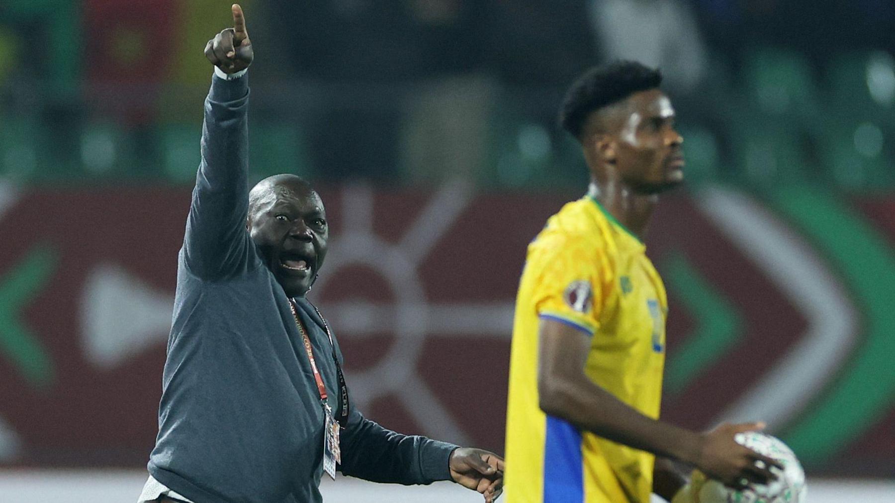 Cameroon boss David Pagou gestures on the touchline as a Gabon player stands ready to take a throw-in