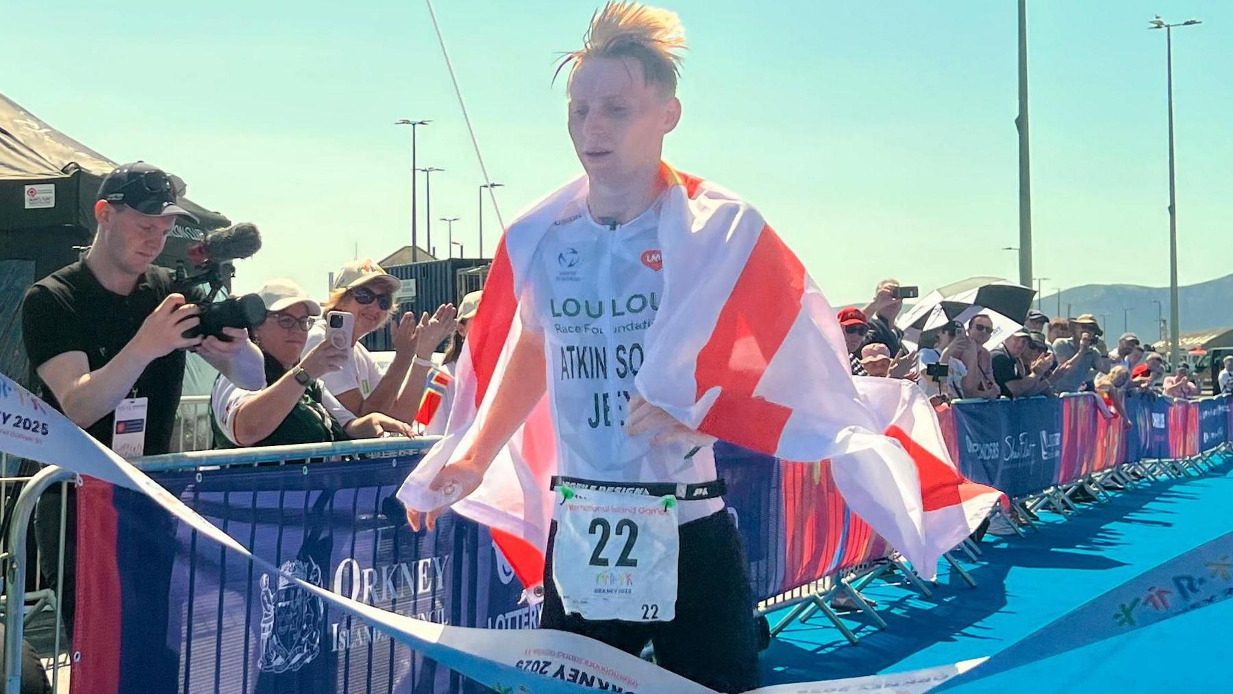 Tom Atkinson crosses the line to win triathlon gold for Jersey