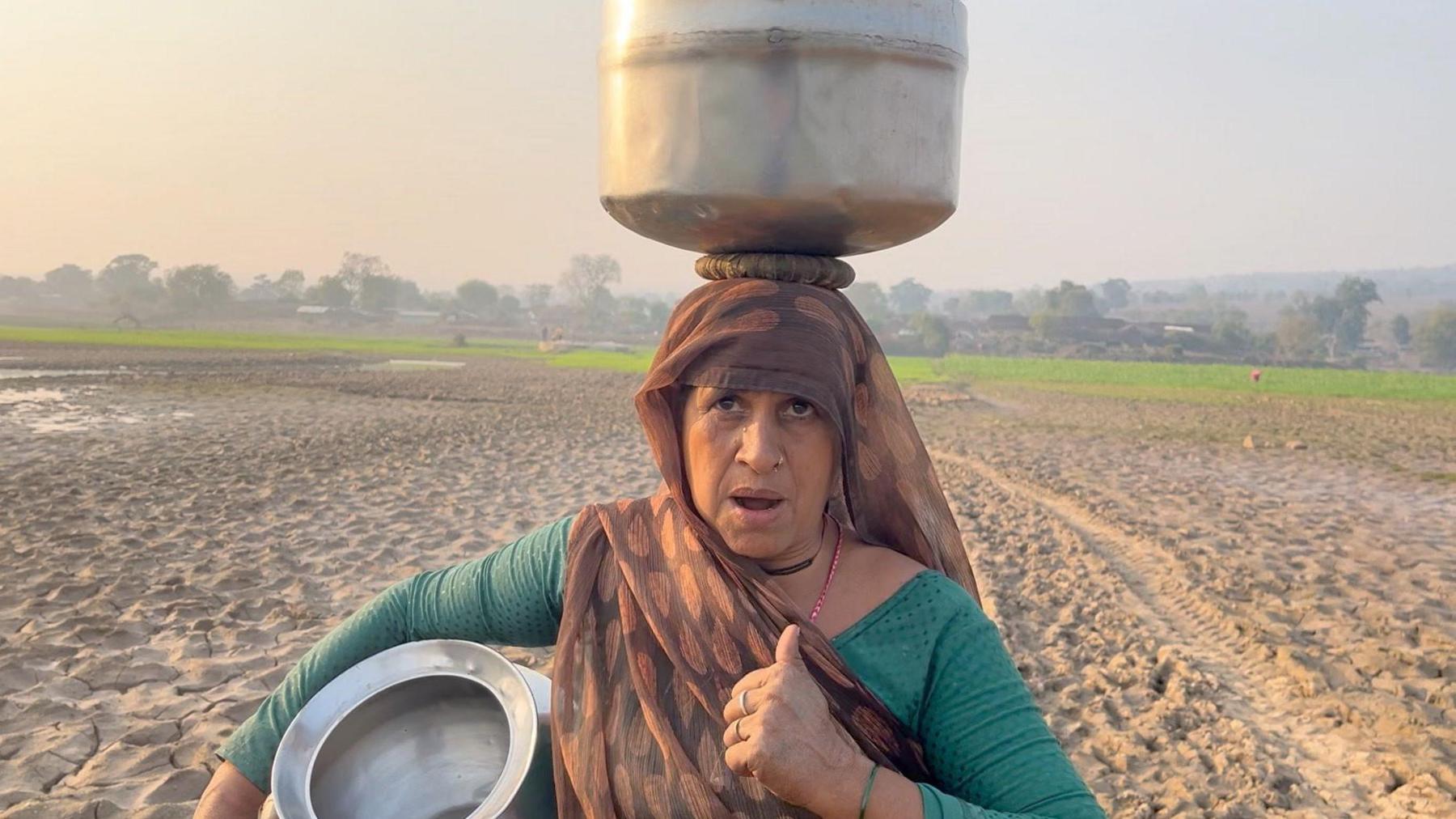 A woman stands at a farm in the Bundelkhand region of Madhya Pradesh 