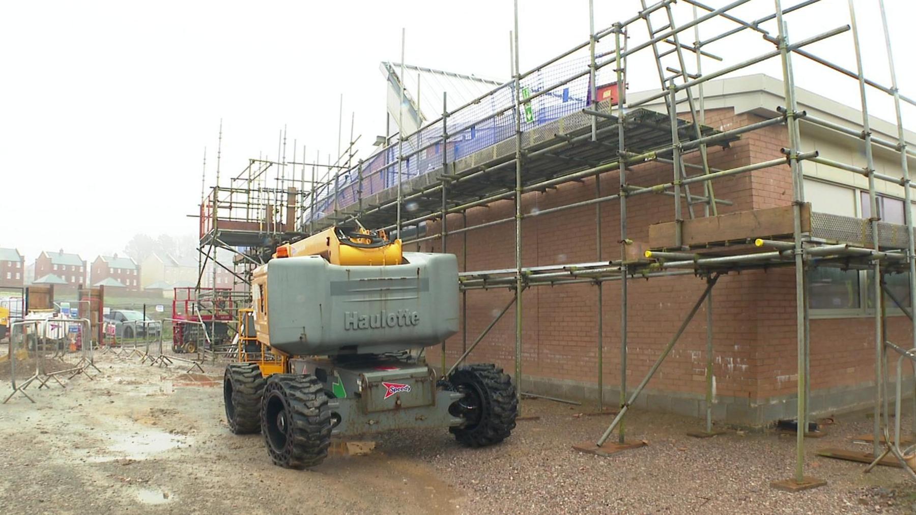 A heavy machine on a rainy building site