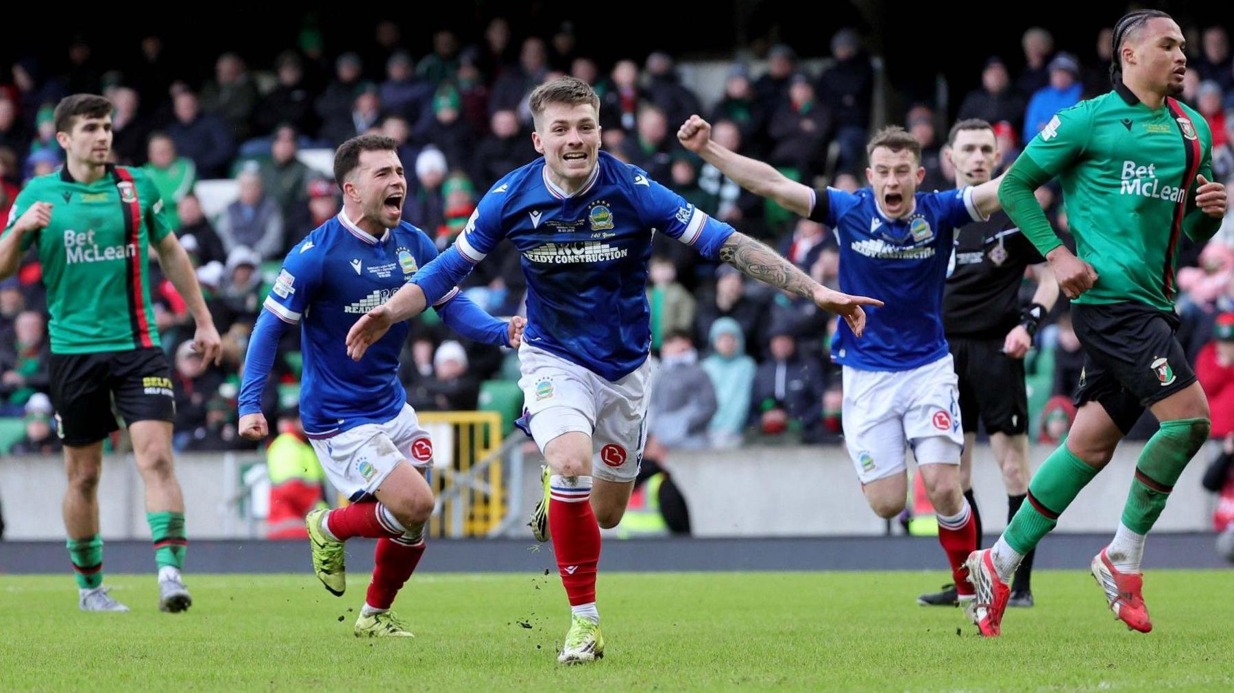 Chris McKee celebrates scoring the winning penalty