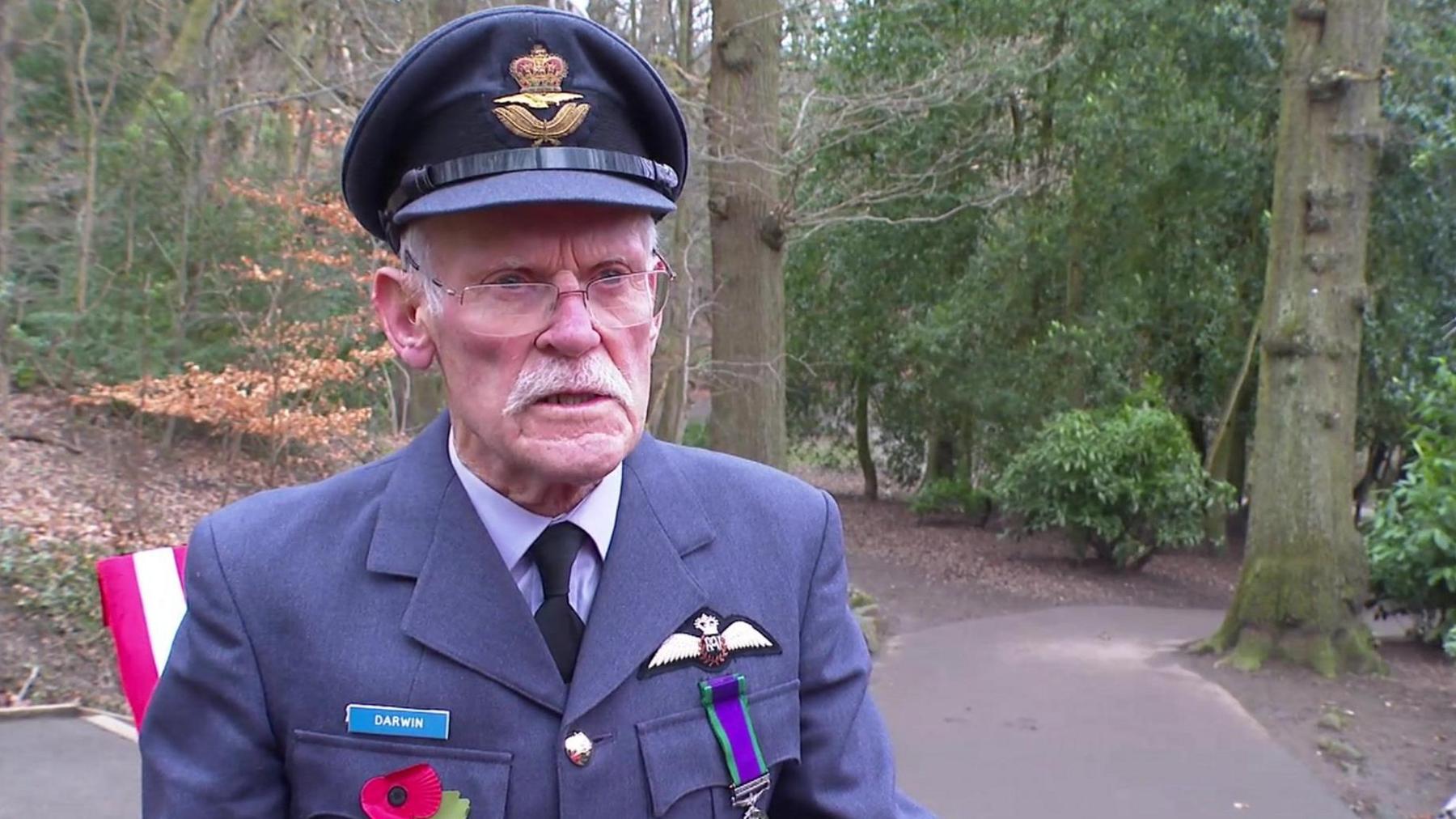 A man in a British military uniform stands in a park - he is Squadron Leader Barry Darwin 